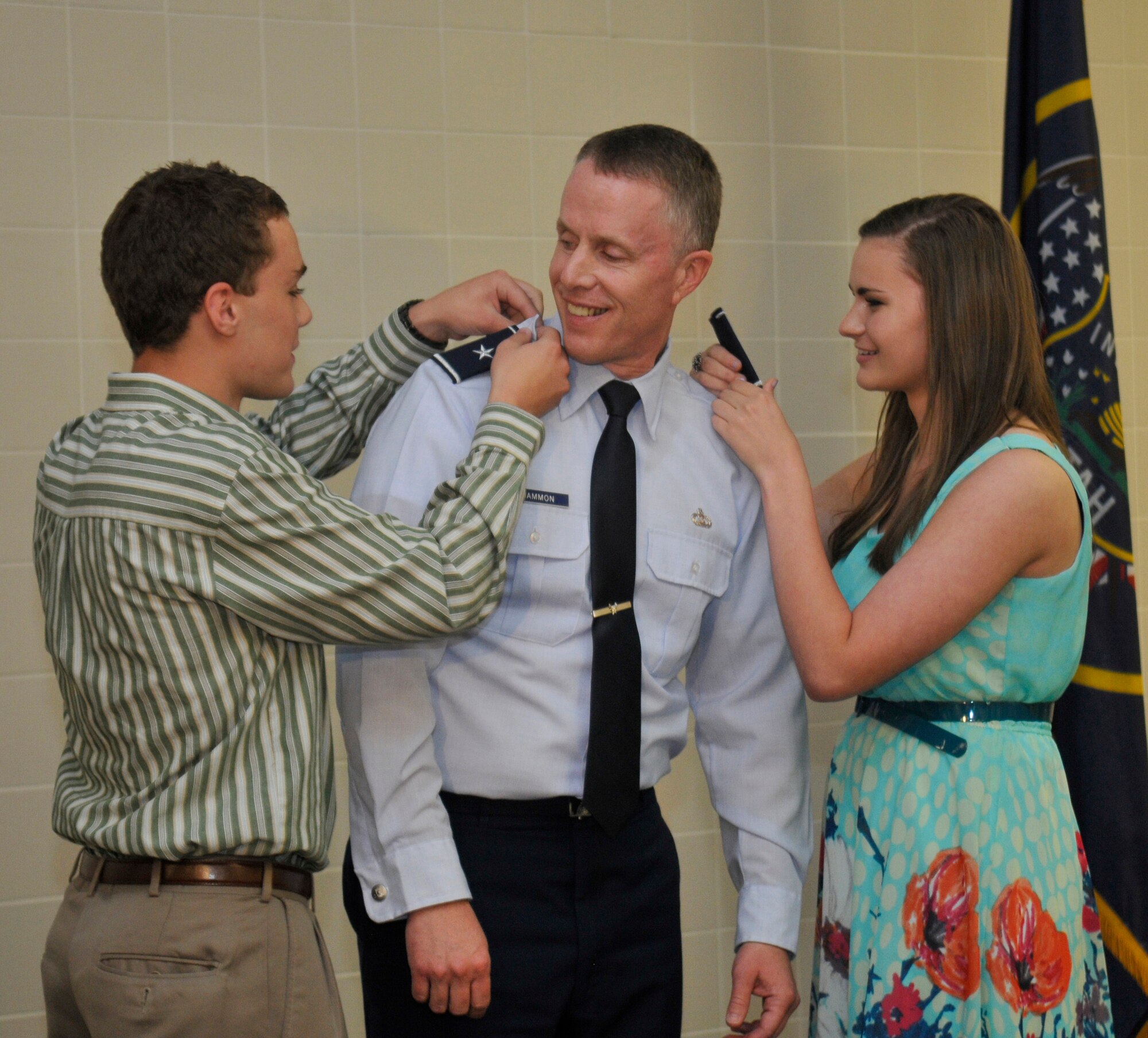 Brig. Gen. Kenneth L. Gammon, Chief of Staff, Utah Joint Force Headquarters Air, has his new rank pinned on by his son Kyle and daughter Gabriella, at his promotion ceremony at the Utah Air National Guard Base in Salt Lake City, on July 14, 2012. (U.S. Air Force photo by Tech. Sgt. Jeremy Giacolletti-Stegall)(Released)