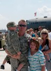 Tech. Sgt. Corey Redder, aircraft electrical and environmental systems craftsman with the 133rd Aircraft Maintenance Squadron, walks from the C-130 Hercules cargo holding his son Jayden Redder. A Minnesota Air National Guard C-130 “Hercules” brings home about thirty Airmen from deployment to Southwest Asia on July 13, 2012 to the St. Paul Air Guard base, greeted by enthusiastic family and friends. Two more C-130 flights are scheduled over the next couple of days, each with about another thirty Airmen aboard, redeploying back to the 133rd Airlift Wing. USAF official photo by Tech. Sgt. Erik Gudmundson