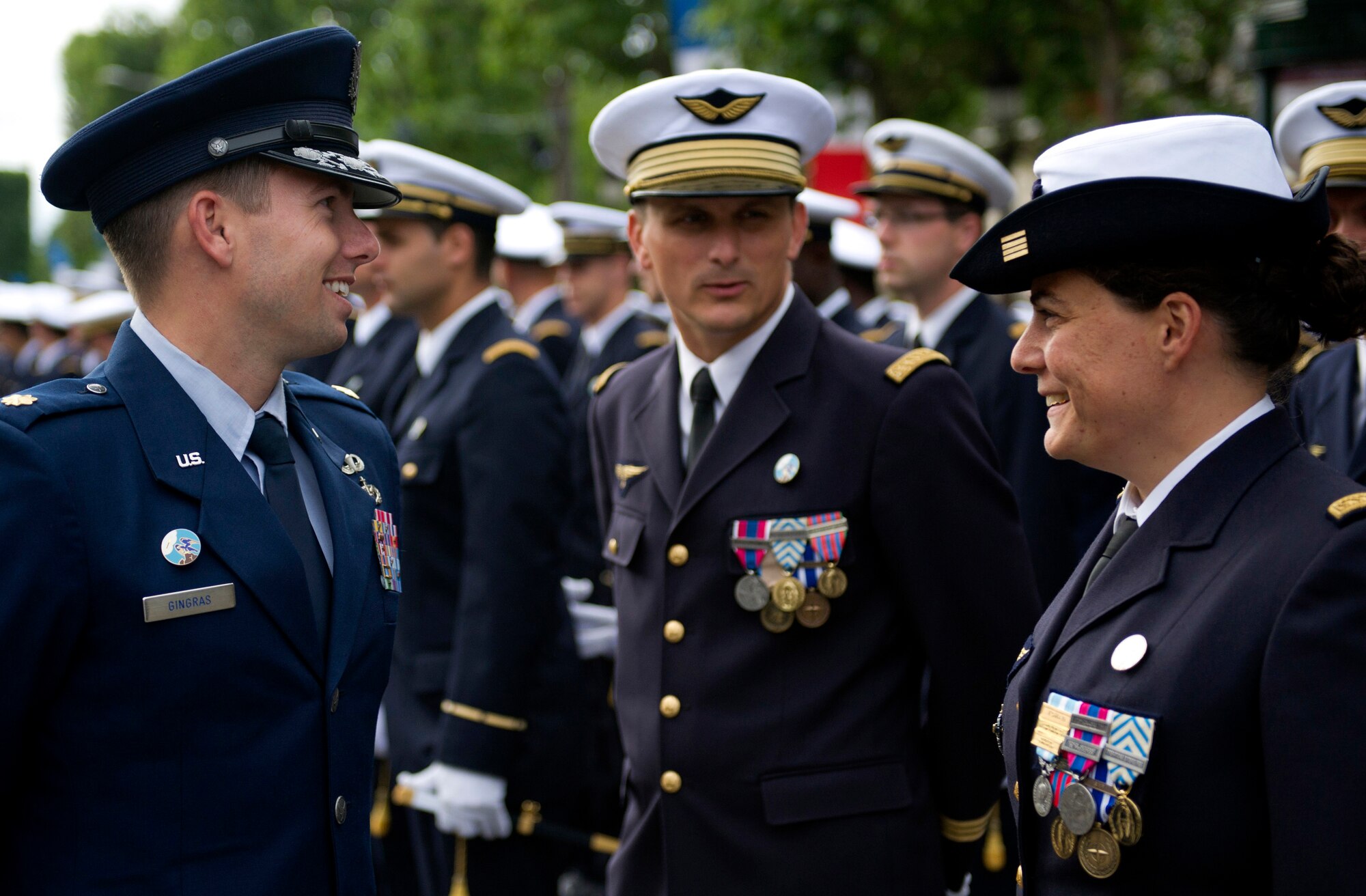 PARIS -- U.S. Air Force Maj. James Gingras, French Air Force Academy exchange officer, left, speaks with his fellow Air Officers Commanding from the French Air Force Academy before marching in the 2012, 14th of July parade in Paris. The 14th of July, known in English by Bastille Day, is the French equivalent of the American 4th of July. It commemorates the attack on the Bastille on July 14, 1989, which preceded the French revolution. (U.S. Air Force photo/Staff Sgt. Benjamin Wilson)