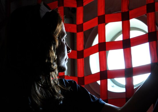 Jennifer Bunke, director of specialized member services for USAA, peers out the porthole of an Air Force Reserve C-130 Hercules during an orientation flight July 13, 2012, over southern Colorado. Bunke, who employs an Air Force Reservist, was one of 26 employers who attended the 302nd Airlift Wing's annual Employer Appreciation Day, which recognizes the support of Reservists' civilian employers. Employers were also introduced to the Colorado State Committee for Employer Support of the Guard and Reserve, a Department of Defense volunteer program that facilitates and promotes a cooperative culture of employer support for National Guard and Reserve service. The 302nd AW is based at Peterson Air Force Base, Colo., and is located in the city of Colorado Springs. (U.S. Air Force photo/Staff Sgt. Stephen J. Collier)
