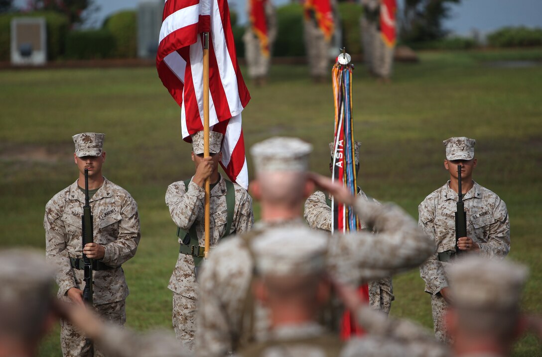 Marines render honors as the National Anthem plays during the 2nd Marine Logistics Group change of command ceremony aboard Camp Lejeune, N.C., July 12, 2012. Maj. Gen. Michael G. Dana, of Schenectady, N.Y., passed the reigns to Col. Mark R. Hollahan, of Decatur, Ga. Hollahan will assume the duties of the office of the commanding general until Brig. Gen. (Select) Edward D. Banta, current military assistant to the secretary of the Navy, takes the helm next month.  (U.S. Marine Corps photo by Staff Sgt. Justin J. Shemanski)