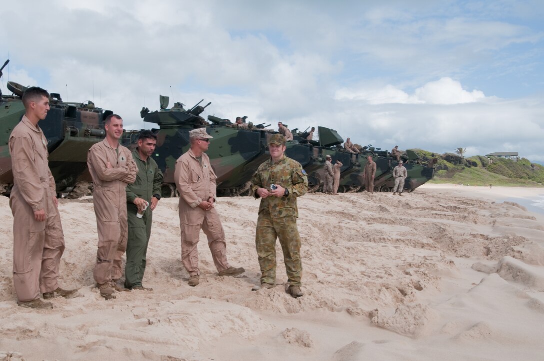 Marines from Combat Assault Company, 3rd Marine Regiment, chat with an Australian Soldier at Pyramid Rock Beach, July 12. More than 50 Marines with CAC, launched 13 amphibious assault vehicles to the USS Essex and Special-Purpose Marine Air-Ground Task Force 3, as part of Rim of the Pacific 2012. Because most amphibious assault ships are based out of San Diego, this is a rare opportunity for the Marines to work aboard a ship in Hawaii, according to 2nd Lt. Kyle Durant, AAV platoon commander with CAC. "It prepares us for on- and off-ship and a lot of inter-service coordination," Durant said. Twenty-two nations, more than 40 ships and submarines, more than 200 aircraft and 25,000 personnel are participating in RIMPAC exercise from June 29 to Aug. 3, in and around the Hawaiian Islands.
