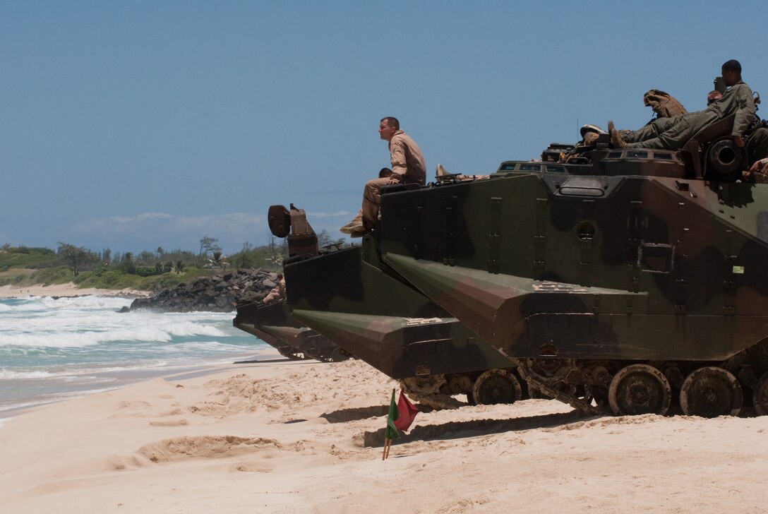 Gunnery Sgt. Chris Shaw, platoon sergeant, Assault Amphibian Vehicle Platoon, Combat Assault Company, 3rd Marine Regiment, awaits launch of their AAVP-7 amphibious assault vehicles at Pyramid Rock Beach, July 12. More than 50 Marines with CAC, launched 13 AAVs to the USS Essex and Special-Purpose Marine Air-Ground Task Force 3, as part of Rim of the Pacific 2012.  Because most amphibious assault ships are based out of San Diego, this is a rare opportunity for the Marines to work aboard a ship in Hawaii, according to 2nd Lt. Kyle Durant, AAV platoon commander with CAC. "It prepares us for on- and off-ship and a lot of inter-service coordination," Durant said. Twenty-two nations, more than 40 ships and submarines, more than 200 aircraft and 25,000 personnel are participating in RIMPAC exercise from June 29 to Aug. 3, in and around the Hawaiian Islands.