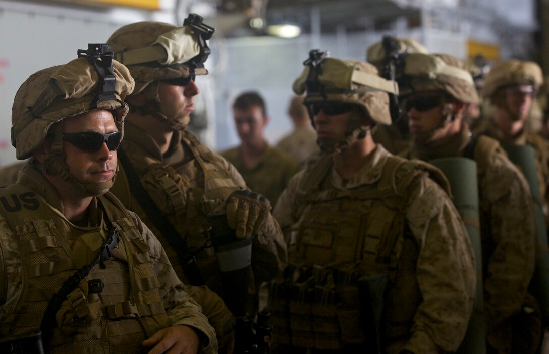 Marines with 1st Battalion, 3rd Marine Regiment, wait to be accounted during a pre-assault landing force drill aboard the USS Essex (LHD-2) during exercise Rim of the Pacific 2012, July 13. Approximately 2,200 personnel from nine nations are participating in RIMPAC as part of the Special Purpose Marine Air-Ground Task Force 3, Combined Force Land Component Command. The CFLCC is conducting amphibious and land-based operations in order to enhance multinational and joint interoperability. More than 40 ships and submarines, 200 aircraft and 25,000 personnel from 22 nations are participating in the biennial RIMPAC exercise from June 29 to Aug. 3, in and around the Hawaiian Islands.