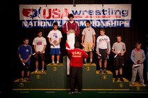Former All-Marine Wrestler Sgt. Jeremy Pederson congratulates Vincent Turk on placing first in the 120-pound weight class of the Cadet National Greco-Roman competition at the Fargodome on July 16. Pederson, a Minnesota native who stood on the same podium when he was in high school, is an operations clerk with Recruiting Station Twin Cities. Two members of the All-Marine wrestling team and the RS Twin Cities Commanding Officer Maj. Kenneth Gawronski also presented awards at the tournament.