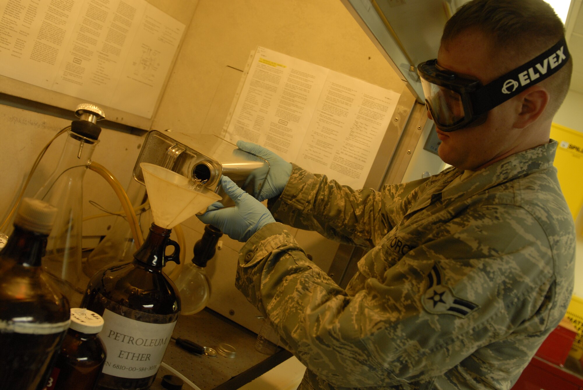 Airman 1st Class Johnson Barnett, 18th Logistics Readiness Squadron fuels lab technician, conducts a bottle method test for the amount of static dissipating additives in the fuel on Kadena Air Base, Japan, July 11, 2012. The lab performs approximately 13,000 tests each year, or a little more than 1,000 per month. (U.S. Air Force photo/Airman 1st Class Malia Jenkins)  