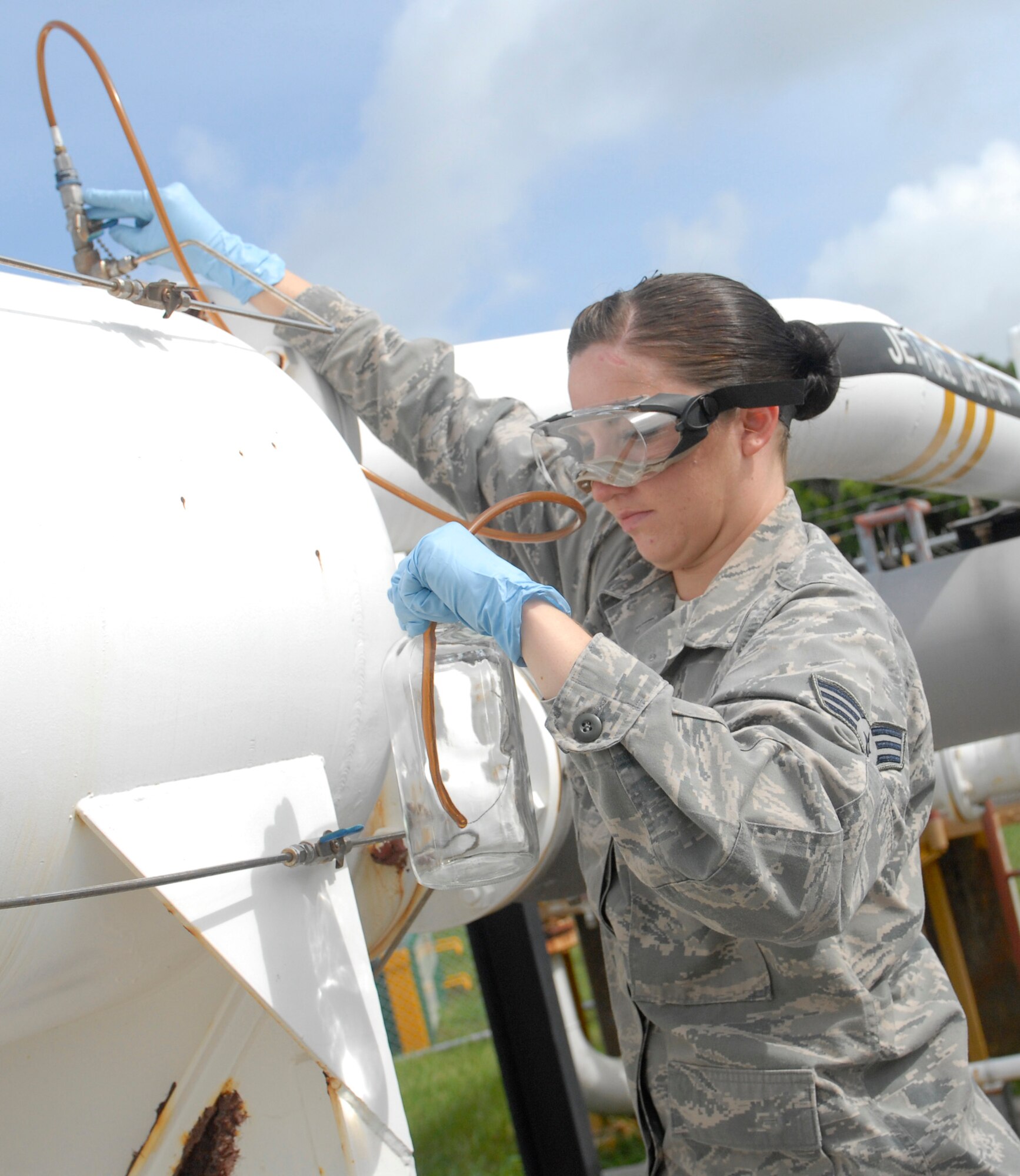 Senior Airman Rachal Eastwood, 18th Logistics Readiness Squadron fuels lab technician, collects a sample of fuel from the Kadena tank farm on Kadena Air Base, Japan, July 11, 2012. Fuel from other branches of service is also tested for its quality before being used. (U.S. Air Force photo/Airman 1st Class Malia Jenkins) 