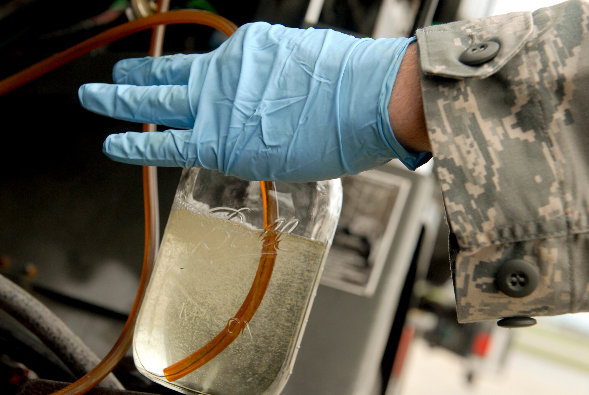 Airman 1st Class Johnson Barnett, 18th Logistics Readiness Squadron fuels lab technician, checks fuel for contaminants on Kadena Air Base, Japan, July 11, 2012. The fuels lab provides approximately 43 million gallons of fuel base-wide and ensures there are low amounts of water and dirt in the fuel before it is distributed to the aircraft and the base. (U.S. Air Force photo/Airman 1st Class Malia Jenkins)