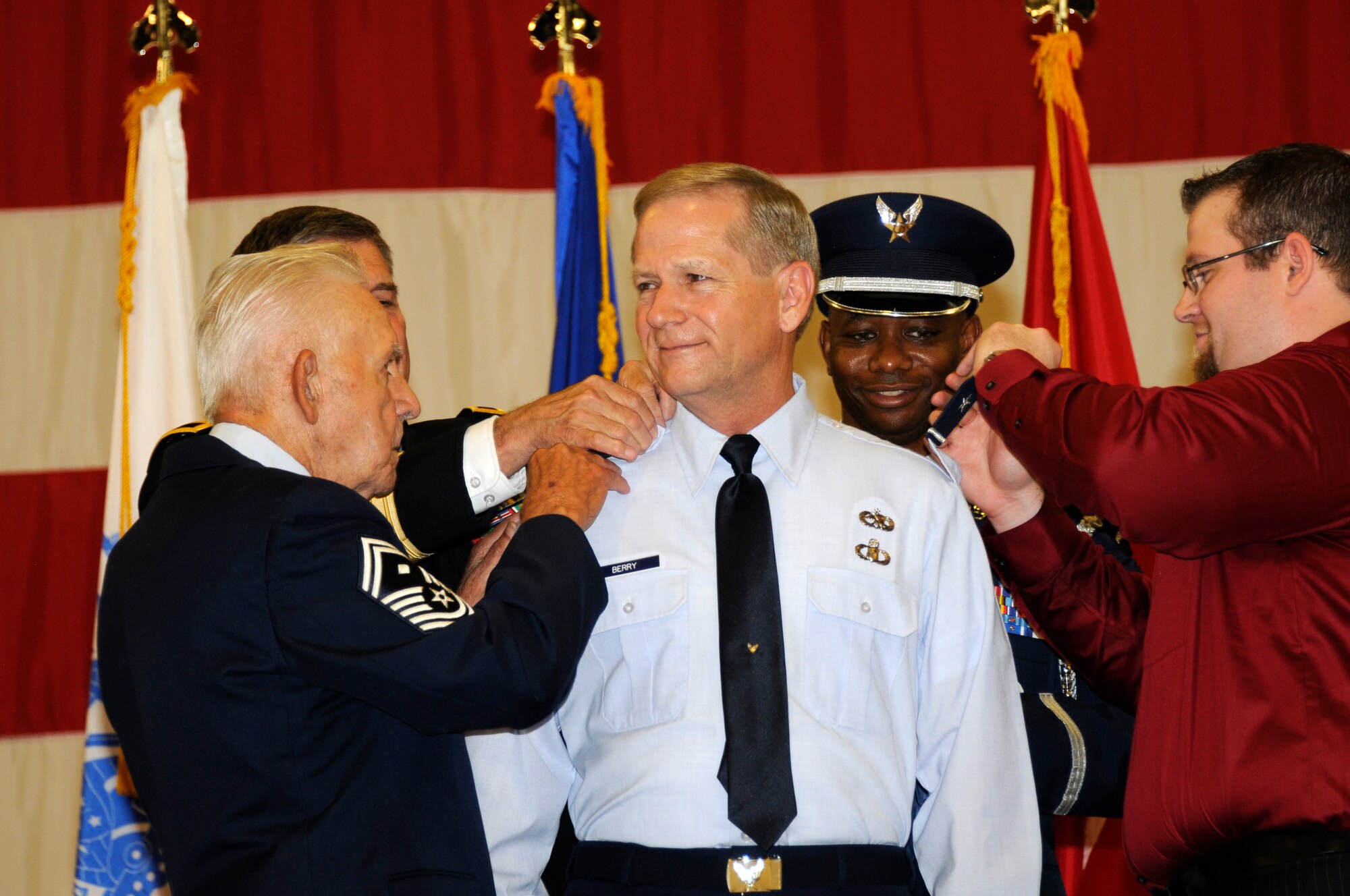 The family of Brig. Gen. Mark H. Berry pins on general stars on Berry’s uniform during his promotion ceremony. Berry became the first officer from the 188th to be promoted to brigadier general in more than 25 years. (National Guard photo by Airman Cody Martin/188th Fighter Wing Public Affairs)