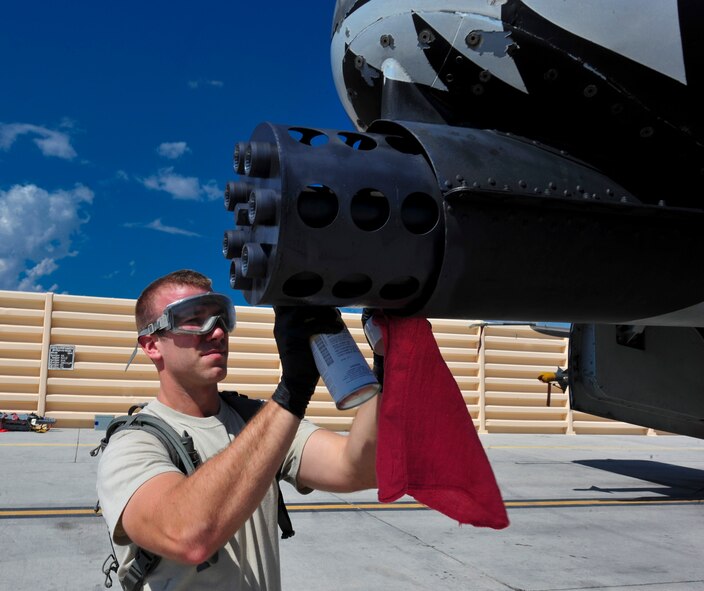U.S. Air Force Senior Airman Andrew LaFontaine, 23d Aircraft Maintenance Squadron, 74th Aircraft Maintenance Unit weapons loader, sprays a rust inhibitor on the barrel of an A-10C Thunderbolt II during a post load inspection at Nellis Air Force Base, Nev. July 16, 2012. LaFontaine is one of more than 150 maintainers deployed from Moody to Nellis in support of Red Flag Exercise 12-4. (U.S. Air Force photo by Staff Sgt. Stephanie Mancha/Released)
