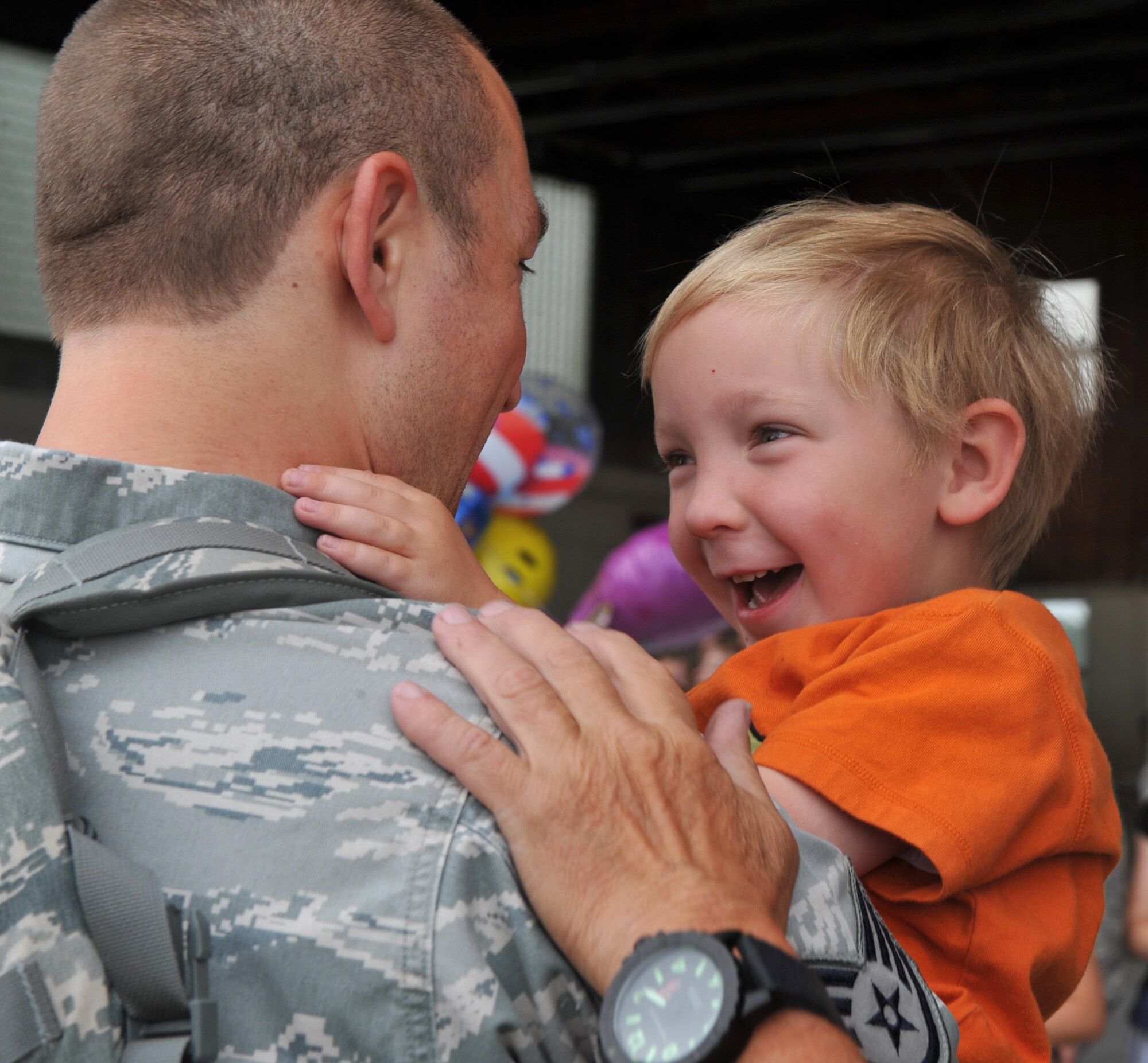 A U.S. Air Force staff sergeant from the 726th Air Control Squadron holds his son July 16, 2012, at Mountain Home Air Force Base, Idaho, after returning from a six-month deployment to Southwest Asia. The squadron was in country to support Operation Enduring Freedom. (U.S. Air Force photo/Airman 1st Class Heather Hayward)