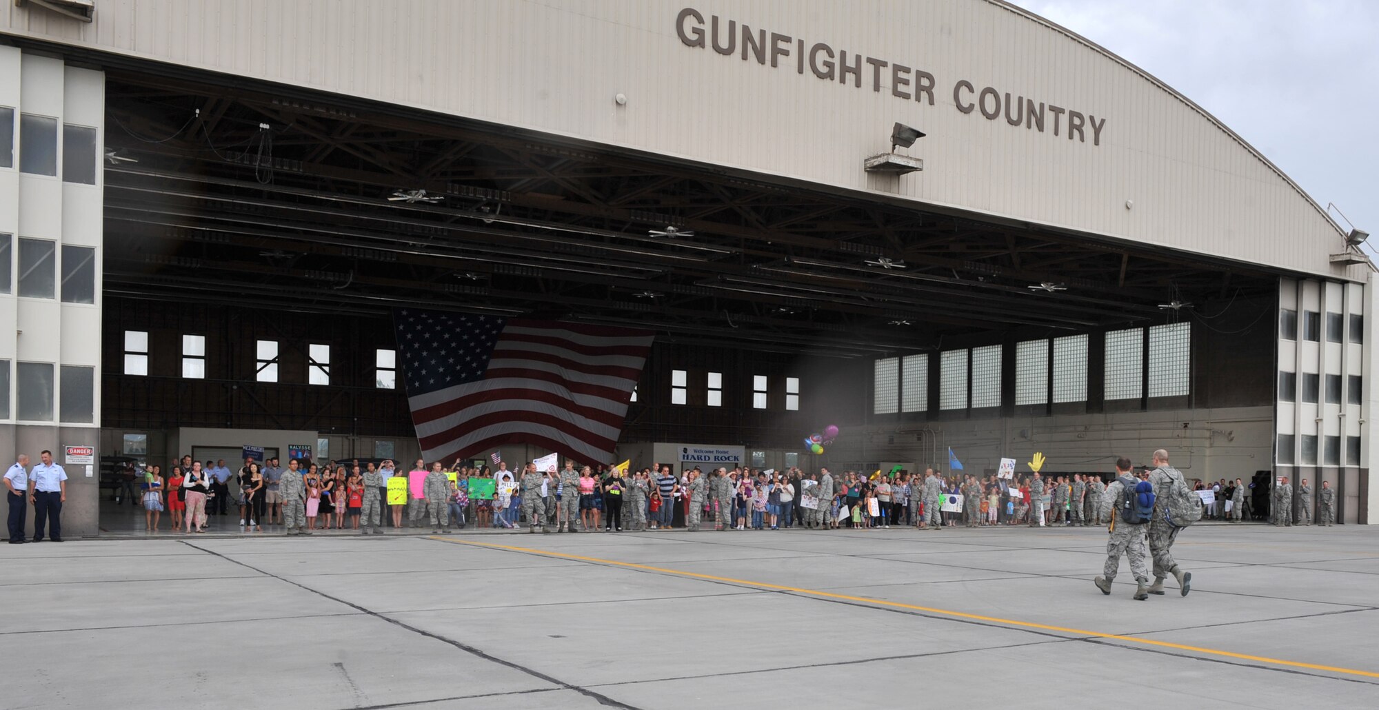 Families, friends and coworkers wait for the return of the 726th Air Control Squadron July 16, 2012, at Mountain Home Air Force Base, Idaho, after a six-month deployment to Southwest Asia. The 726th ACS tackles a wide-spread mission, including enemy surveillance and identification, weapons control, joint and combined data-link connectivity, theater air defense, and battle management of assigned air assets. (U.S. Air Force photo/Airman 1st Class Heather Hayward)