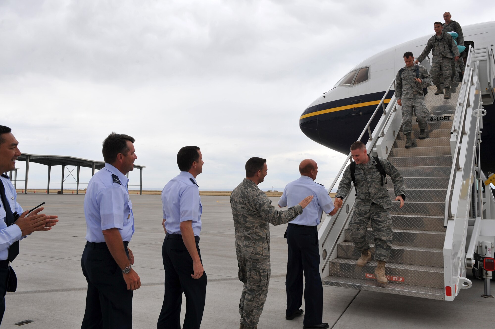 U.S. Air Force Airmen assigned to the 726th Air Control Squadron shake hands with base leadership as they disembark from a plane July 16, 2012, at Mountain Home Air Force Base, Idaho, after a six-month deployment to Southwest Asia. During their deployment, the squadron became the 71st Expeditionary Air Control Squadron, executing tactical control of the air campaign through the operation and maintenance of various tactical sensors and communications. (U.S. Air Force photo/Airman 1st Class Heather Hayward)