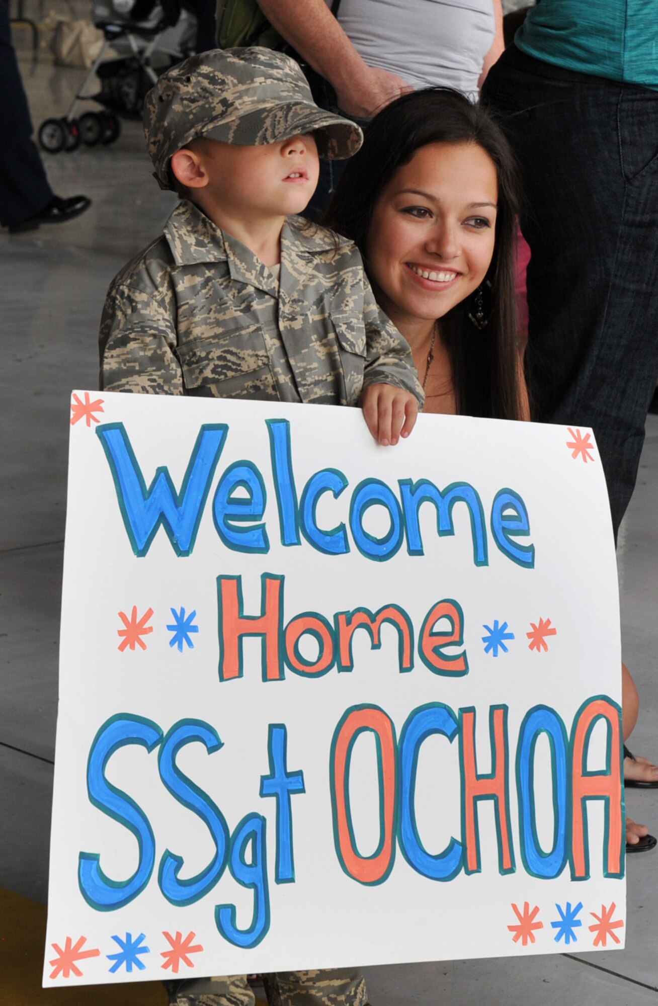 Family members of a deployed staff sergeant from the 726th Air Control Squadron hold a sign as they await the arrival of their loved one July 16, 2012, at Mountain Home Air Force Base, Idaho. The 726th ACS has been deploying over half of the squadron to Southwest Asia since 2003 in support of air control operations and direct combat support. (U.S. Air Force photo/Airman 1st Class Heather Hayward)