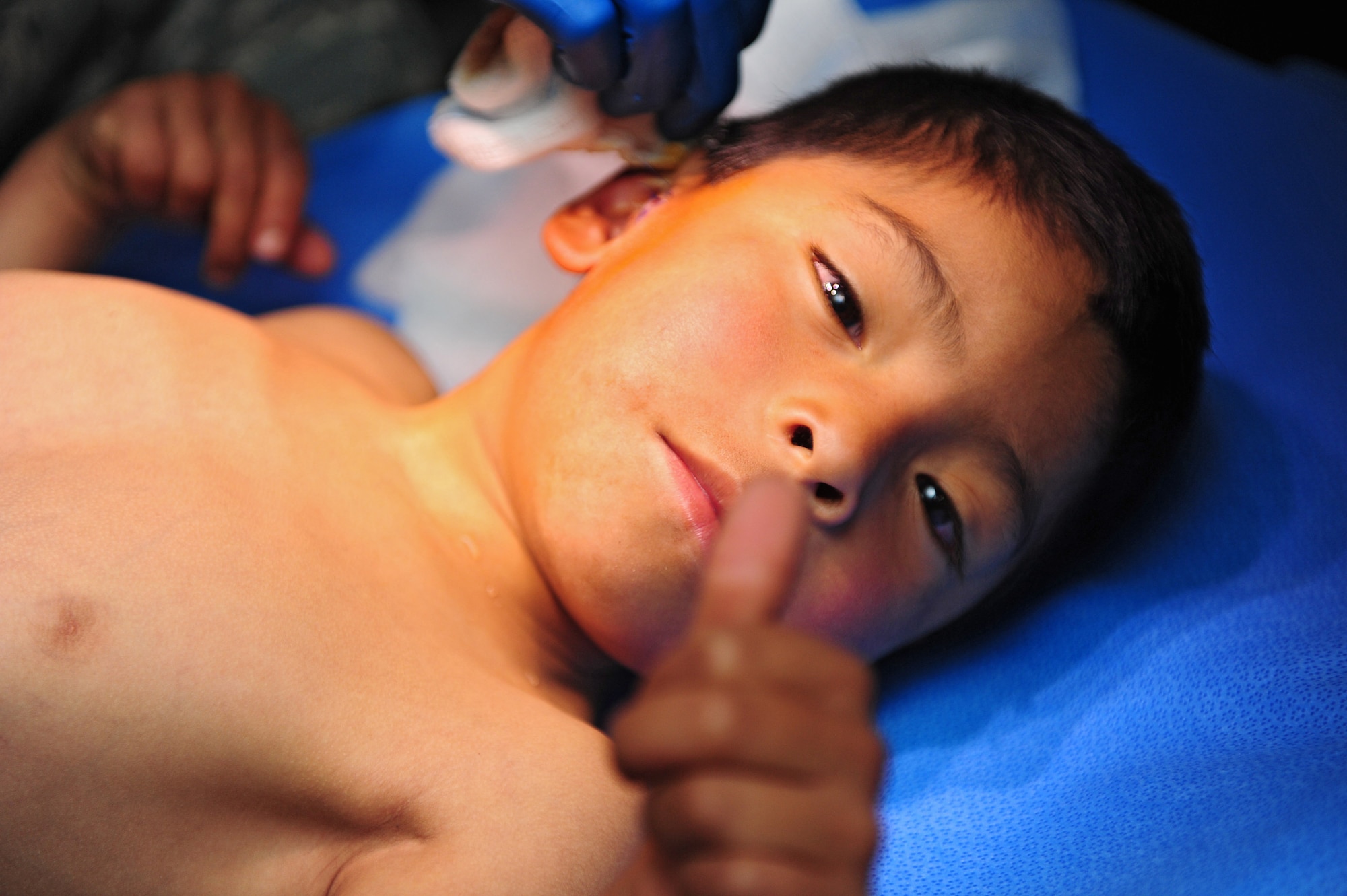 A Peruvian boy gives a thumbs up after surgery at an Expeditionary Medical Support mobile field hospital in Huancavelica, Peru, July 2, 2012, during New Horizons 2012. New Horizons is a U.S. Southern Command-sponsored annual series of joint humanitarian assistance exercises deploying U.S. military engineers, veterinarians, medics and other professions to Central and South American nations for training, construction projects and to provide humanitarian and medical services. (U.S. Air Force photo by Staff Sgt. Michael C. Zimmerman/Released)





