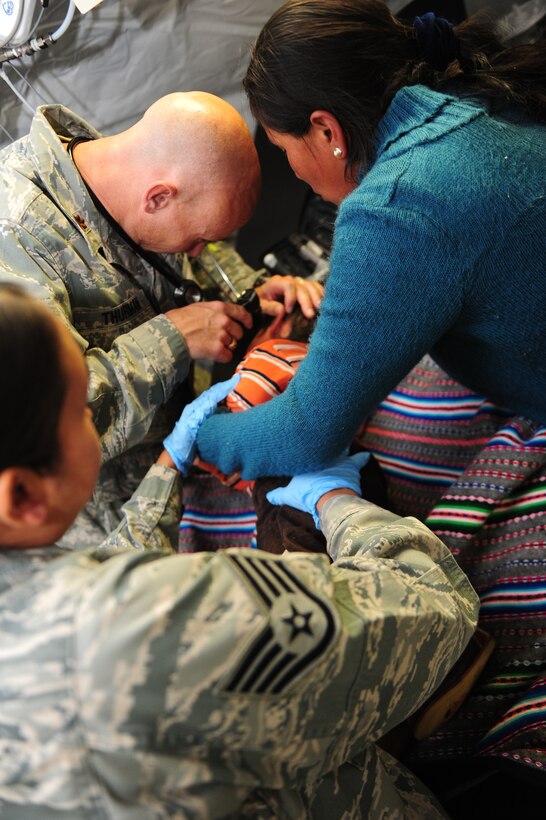 U.S. Air Force doctors and medics help a sick Peruvian boy at an expeditionary dental clinic in an Expeditionary Medical Support mobile field hospital in Huancavelica, Peru, July 3, 2012, as part of New Horizons 2012. New Horizons is a U.S. Southern Command-sponsored annual series of joint humanitarian assistance exercises deploying U.S. military engineers, veterinarians, medics and other professions to Central and South American nations for training, construction projects and to provide humanitarian and medical services. (U.S. Air Force photo by Staff Sgt. Michael C. Zimmerman/Released)



