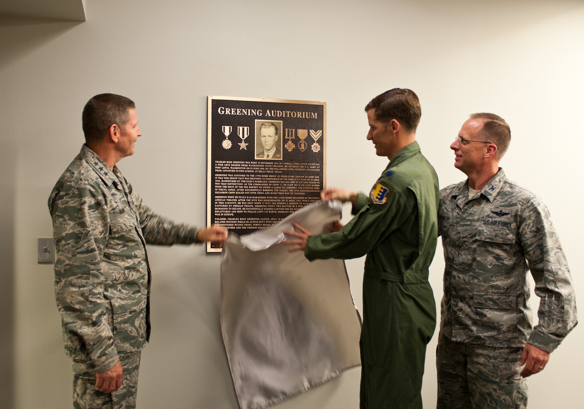 Lt. Gen. Robin Rand, 12th Air Force commander, Lt. Col. Christopher Clark, 432nd Attack Squadron commander, and Col. Mark Weatherington, 28th Bomb Wing commander, unveil a plaque dedicating the 432nd ATKS auditorium to Col. Ross Greening, a former member of the 432nd Bomb Squadron in the 1940s, at Ellsworth Air Force Base, S.D., July 12, 2012. The auditorium will be used for conducting aircrew briefings prior to combat support sorties, mass briefings for intelligence updates and aircrew/squadron personnel training vital to Ellsworth’s MQ-9 operations. (U.S. Air Force photo by Airman 1st Class Alystria Maurer)