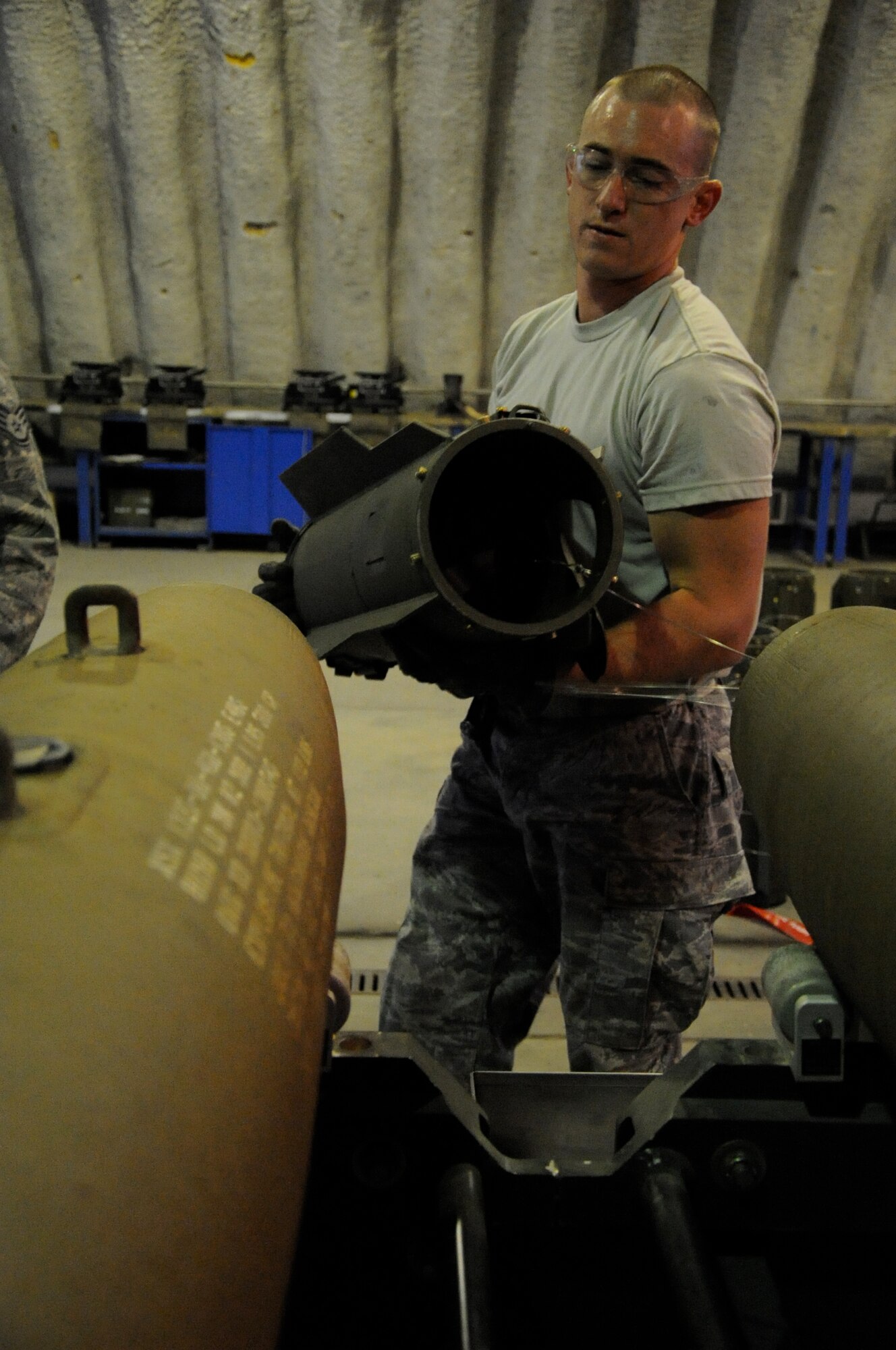 EIELSON AIR FORCE BASE, Alaska -- Senior Airman Brady Curtis-Quackenbush, munitions technician, builds a Mark-82 for a live-employment exercise with the  A-10 Thunderbolt II aircraft assigned to the 442nd Fighter Wing and deployed here for training. The munitions technicians are assigned to the 442nd Maintenance Squadron, part of the 442nd FW, Air Force Reserve unit at Whiteman Air Force Base, Mo. (U.S. Air Force photo/Staff Sgt. Danielle Johnston)