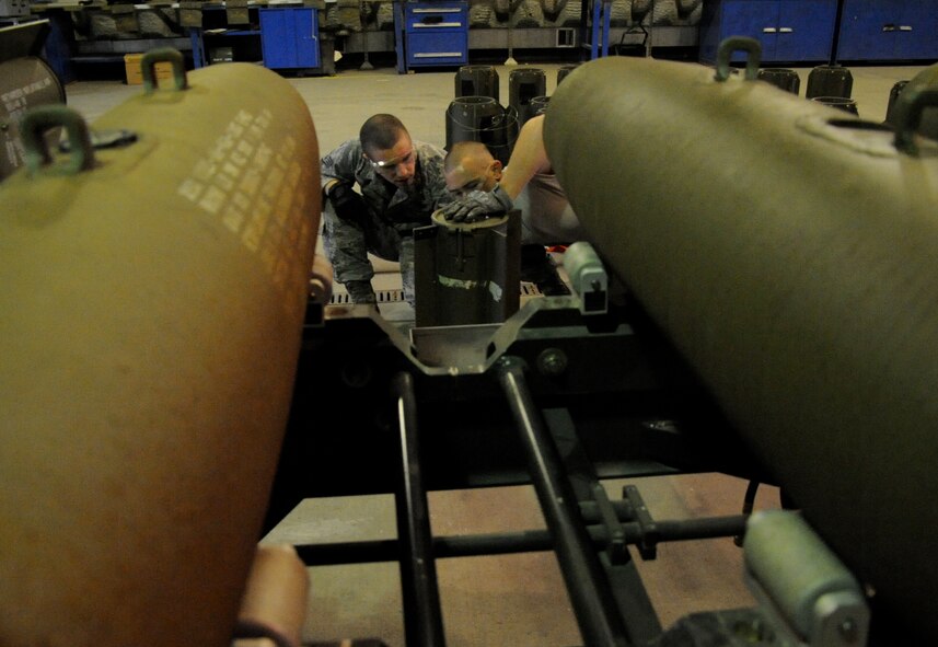 EIELSON AIR FORCE BASE, Alaska -- Staff Sgt. David Rogers and Senior Airman Brady Curtis-Quackenbush, munitions technicians, build a Mark-82 for a live-employment exercise with the  A-10 Thunderbolt II aircraft assigned to the 442nd Fighter Wing and deployed here for training. The munitions technicians are assigned to the 442nd Maintenance Squadron, part of the 442nd FW, Air Force Reserve unit at Whiteman Air Force Base, Mo. (U.S. Air Force photo/Staff Sgt. Danielle Johnston)