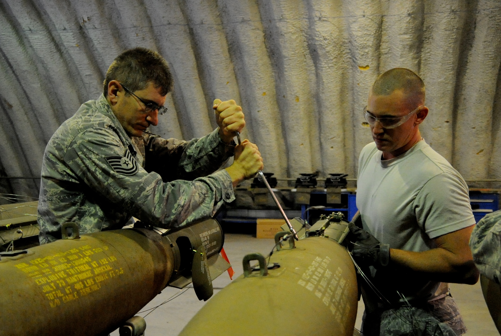 EIELSON AIR FORCE BASE, Alaska -- Master Sgt. Peter Kavanaugh and Senior Airman Brady Curtis-Quackenbush, munitions technicians, build a Mark-82 for a live-employment exercise with the  A-10 Thunderbolt II aircraft assigned to the 442nd Fighter Wing and deployed here for training. The munitions technicians are assigned to the 442nd Maintenance Squadron, part of the 442nd FW, Air Force Reserve unit at Whiteman Air Force Base, Mo. (U.S. Air Force photo/Staff Sgt. Danielle Johnston)