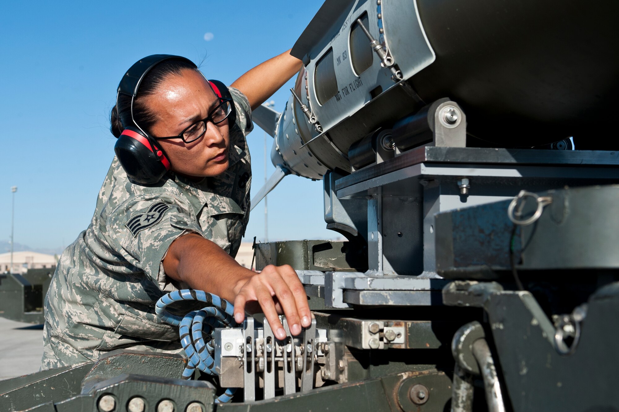 U.S. Air Force Staff Sgt. Elisa Guzman, 57th Aircraft Maintenance Squadron aircraft armament systems journeyman, prepares to upload a guided bomb unit-32 July 6, 2012, at Nellis Air Force Base, Nev. Airmen were tasked to upload munitions to two F-16 Fighting Falcons, three F-15 Eagles, one F22 Raptor, and one A-10 Warthog. (U.S. Air Force photo by Airman 1st Class Jason Couillard)