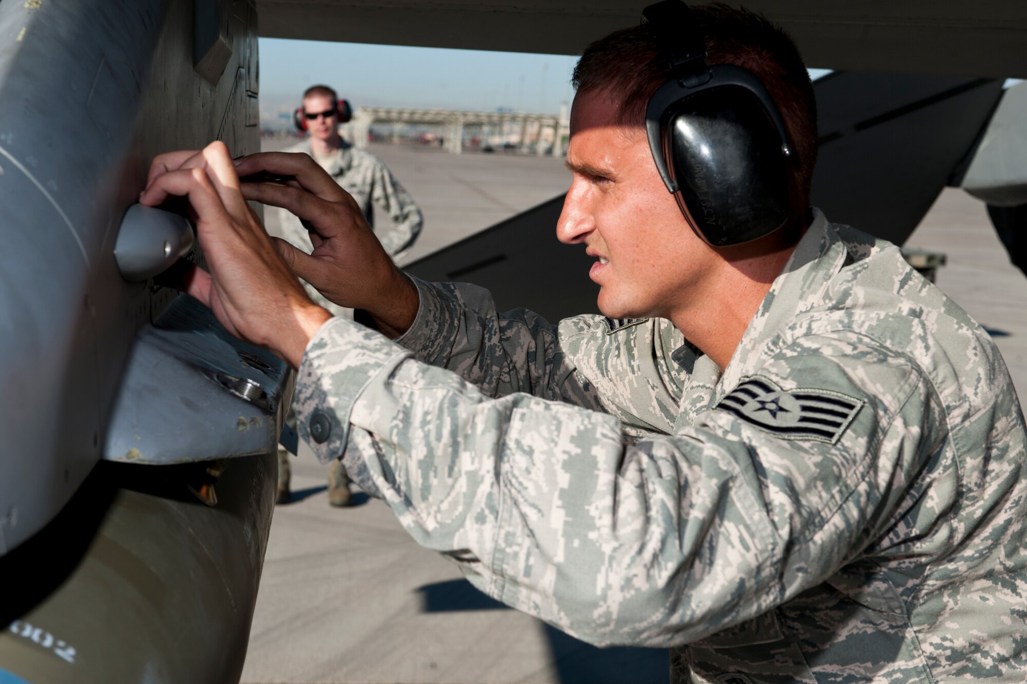 U.S. Air Force Staff Sgt. Mike Briston, 57th Aircraft Maintenance Squadron aircraft armament systems craftsman, checks panels on an F-16 Fighting Falcon during the quarterly load crew competition July 6, 2012, at Nellis Air Force Base, Nev. Airmen that compete are chosen by their section chiefs by looking at their positive statistics. (U.S. Air Force photo by Airman 1st Class Jason Couillard)