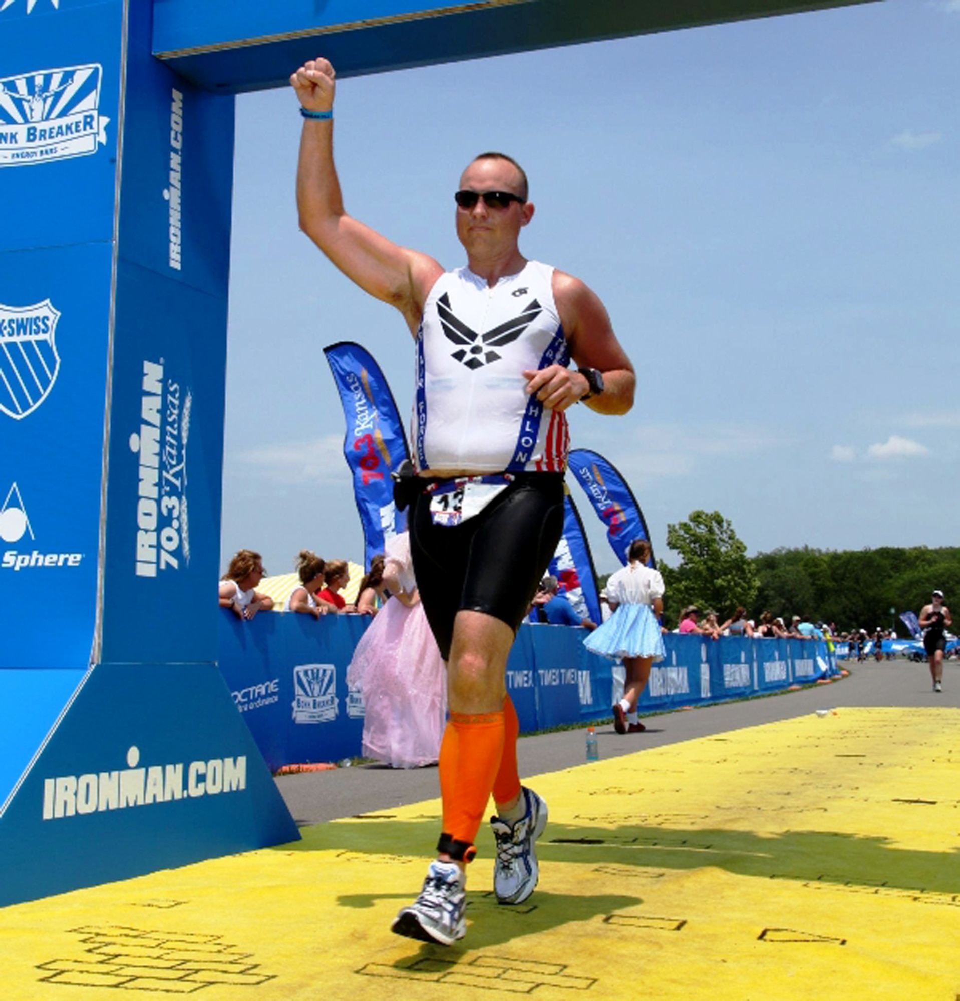 Capt. David Wennerstrom, 442nd Civil Engineer Squadron assistant operations flight commander, pumps his fist as he crosses the finish-line of the Iron Man 70.3 in Lawrence, Kan. June 20, 2012. Wennerstrom deployed to Afghanistan in 2011 where he began training for marathons and Ironman competitions, which entail: 2.5 miles swimming, 112 miles cycling and 26 miles running, within 17 hours. The 442nd CES is part of the 442nd Fighter Wing, an A-10 Thunderbolt II Air Force Reserve unit at Whiteman Air Force Base, Mo. (U.S. Air Force photo/courtesy photo)