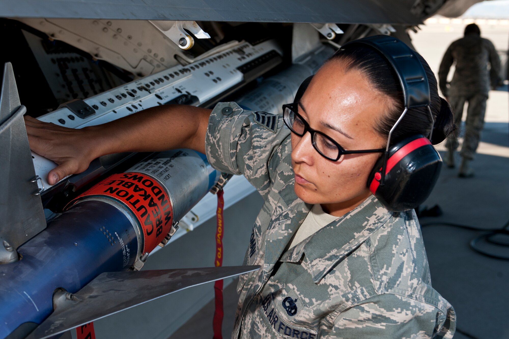 U.S. Air Force Staff Sgt. Elisa Guzman, 57th Aircraft Maintenance Squadron aircraft armament systems journeyman, checks an AIM-9 Sidewinder air-to-air missile during the quarterly load crew competition July 6, 2012, at Nellis Air Force Base, Nev. The winners of the competition receive 3 days off designated by the 57th Wing Commander, a traveling trophy, and bragging rights for the second quarter. (U.S. Air Force photo by Airman 1st Class Jason Couillard)