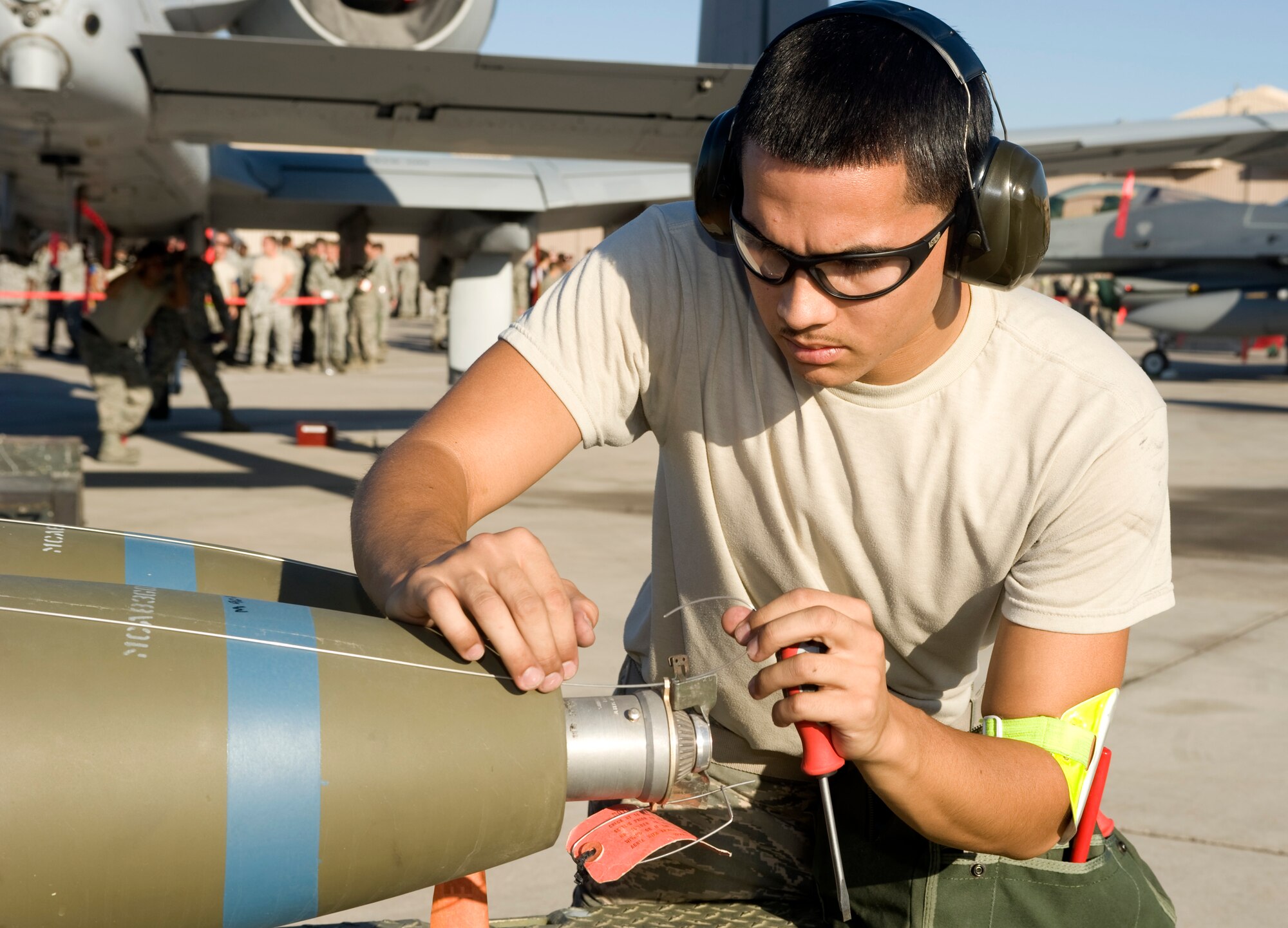U.S. Air Force Senior Airman Jonathan Gonzalez, 757th Aircraft Maintenance Squadron weapons load crew member, prepares a Mk-82 bomb to be loaded during a quarterly load crew competition July 6, 2012, at Nellis Air Force Base, Nev. Weapons load teams are evaluated for use of the checklist, safety, and overall speed. (U.S. Air Force photo by Airman 1st Class Matthew Lancaster)
