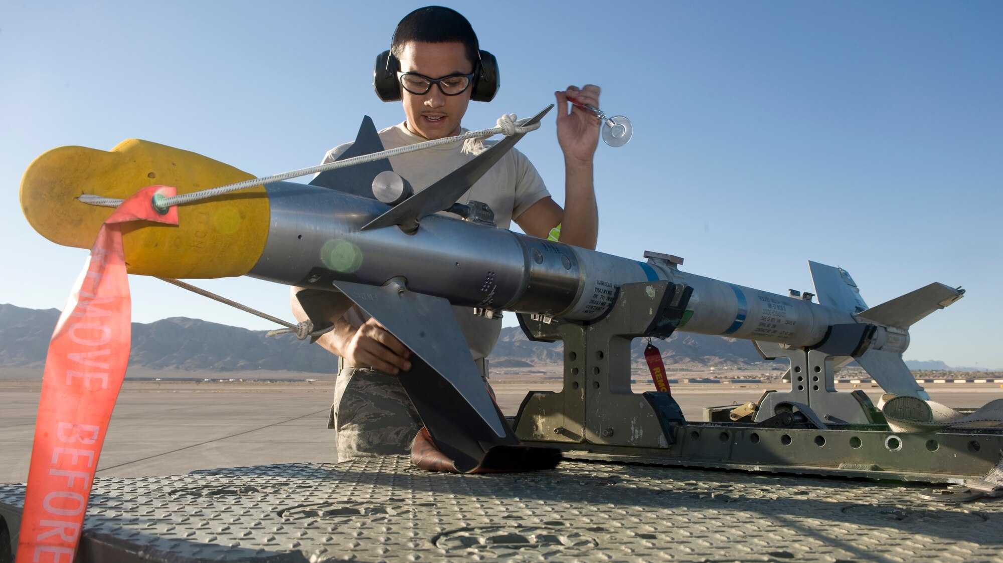 U.S. Air Force Senior Airman Jonathan Gonzalez, 757th Aircraft Maintenance Squadron weapons load crew member, inspects an AIM-9 Sidewinder air-to-air missile during a quarterly load crew competition July 6, 2012, at Nellis Air Force Base, Nev. The load crew competition gives the crews an opportunity to display their skills to the wing. (U.S. Air Force photo by Airman 1st Class Matthew Lancaster)
