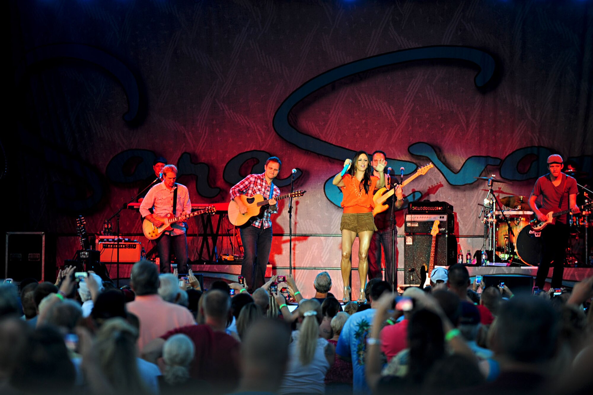 Fans cheer as country singer Sara Evans takes the stage during a concert at Ft. Eustis, Va., July 13, 2012. The Joint Base Langley-Eustis Morale, Welfare and Recreation center, and the Hampton Roads United Service Organization teamed up to host the event for Service members and civilians in the local area. (U.S. Air Force photo by Staff Sgt. Ashley Hawkins/Released)