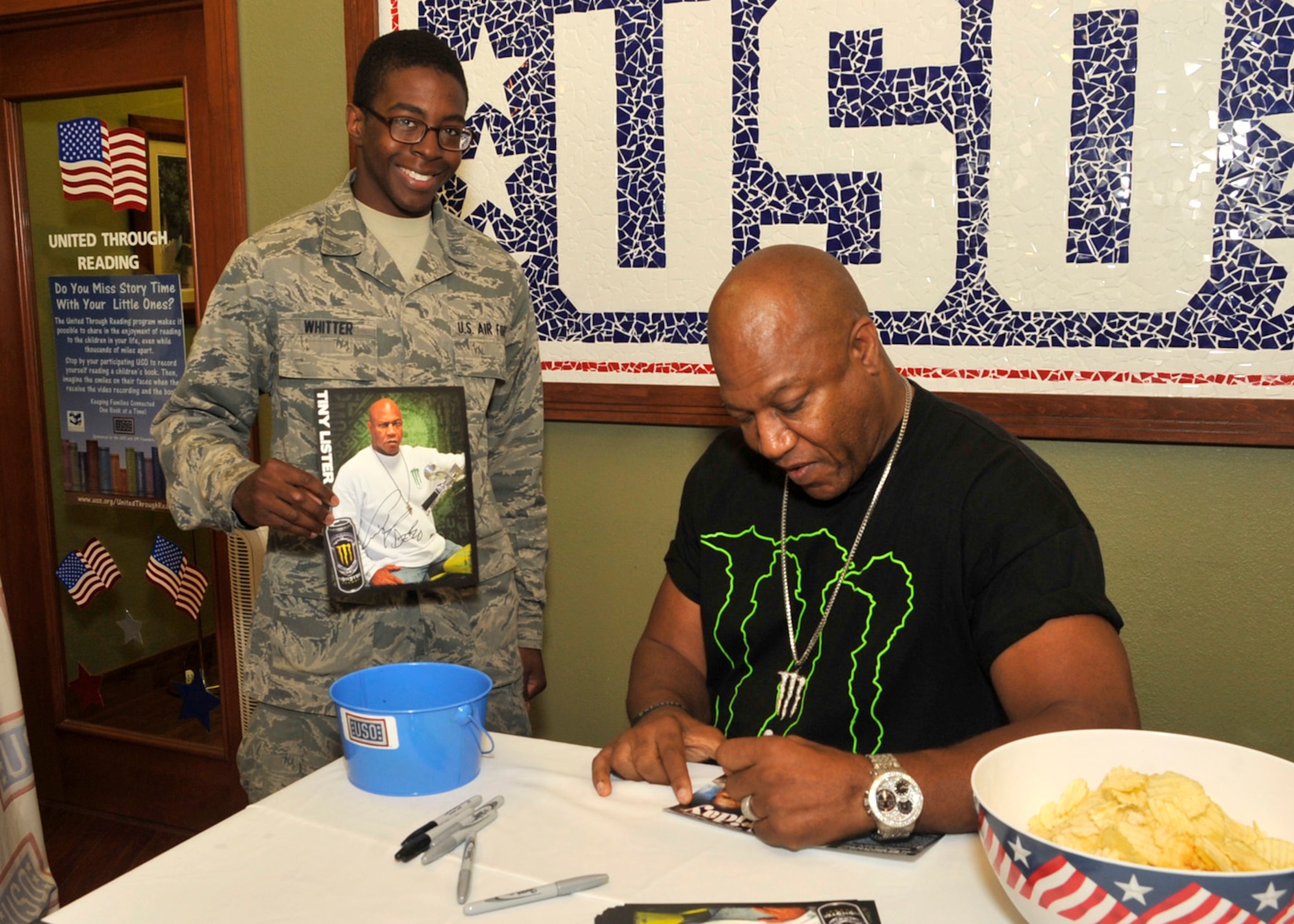 Tiny Lister signs an autograph on a DVD for Senior Airman Keith Whitter, an aircraft hydraulic systems technician with the 512th Maintenance Squadron, July 12, 2012, at the United Services Organization on Dover Air Force Base, Del. Lister signed autograph pictures of himself as well as copies of the movie "Friday."