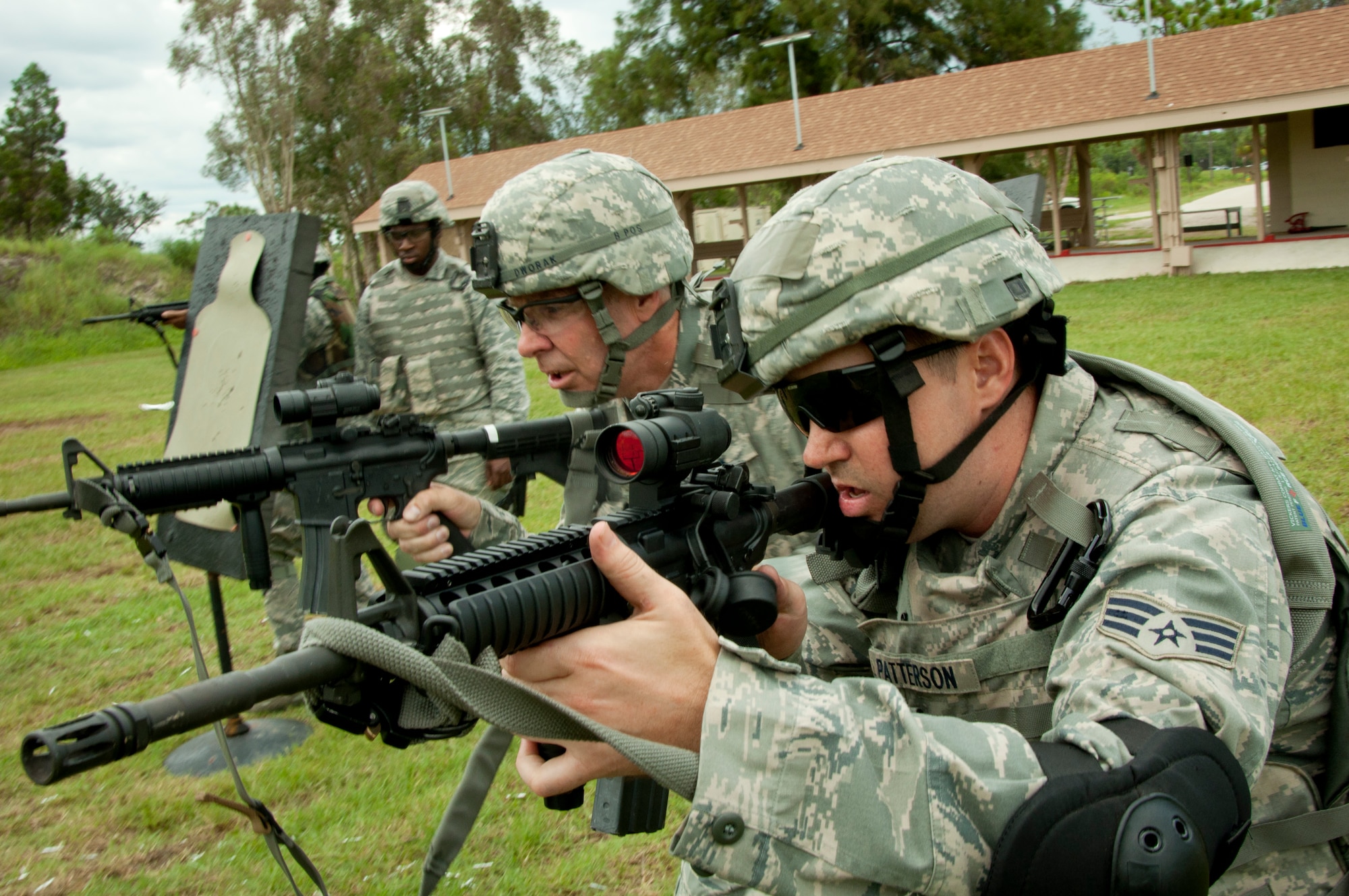 MACDILL AIR FORCE BASE, Fla. –Technical Sgt. Walter Dworak, a squad leader, left, and Senior Airman James Patterson, a fire team member, right, engage enemy targets during their recent Unit Training Assembly July 15, 2012.  The Air Force's Shoot, Move, Communicate Course teaches 927th Security Forces Squadron members how to operate in combat as a team and squad, laying down accurate fire while moving without injuring their teammates. FX DyMark rounds were used for safety purposes.  (Official U.S. Air Force photo/Staff Sgt. Shawn Rhodes)