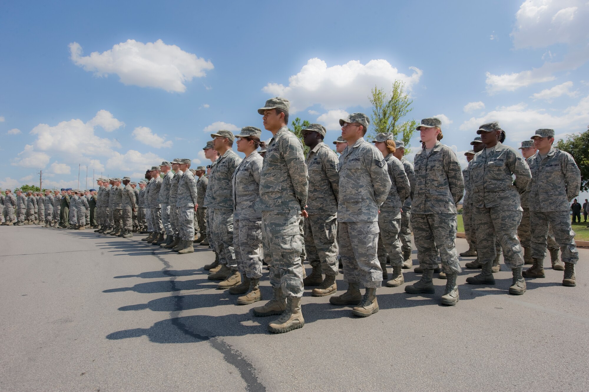 Dyess Airmen wait for the flag to be lowered during a wing retreat ceremony July 13, 2012, at Dyess Air Force Base, Texas. A retreat ceremony signifies the end of a duty day and is also a way to pay tribute to the American flag. (U.S. Air Force photo by Airman 1st Class Jonathan Stefanko/ Released)