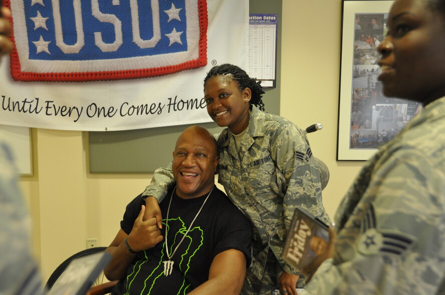 Senior Airman Ronisha Coleman, poses with actor Tiny "Debo" Lister July 12, 2012 at Dover Air Force Base, Del. Lister came to Dover as part of a USO-sponsored visit and met with the men and women who support the mortuary mission. Colman is deployed to Air Force Mortuary Affairs Operations. She is assigned to the 315th Force Support Squadron, Charleston Air Force Base, S.C. (U.S. Air Force photo/Christin Michaud)