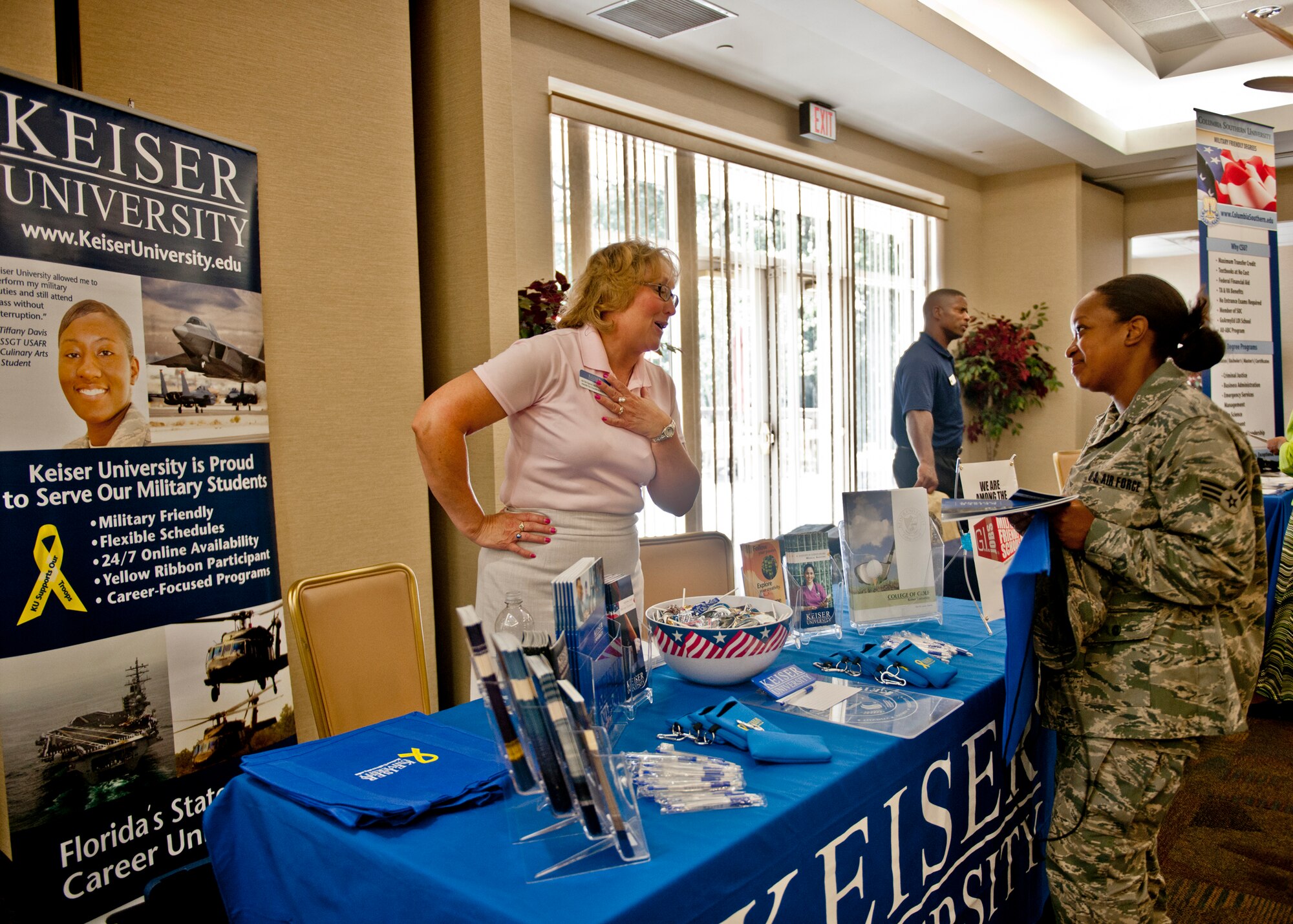 A representative from Keiser University talks to U.S. Air Force Senior Airman Caitlin Ollison, 23d Equipment Maintenance Squadron, about the school’s programs during an education fair July 12, 2012, at Moody Air Force Base, Ga. Many of the colleges displayed at the event are military friendly. (U.S. Air Force photo by Senior Airman Eileen Meier/Released)