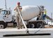 Staff Sgt. Alonzo Marquez, 819th Red Horse Squadron of Malmstrom AFB, Mont., levels freshly poured concrete July 17, 2012, at Dyess Air Force Base, Texas. The poured concrete is for the foundation of a 8,500-square-foot facility that will provide the 7th CES a new logistics building, consolidating multiple facilities used by the squadron. (U.S. Air Force photo by Airman 1st Class Peter Thompson/ Released)