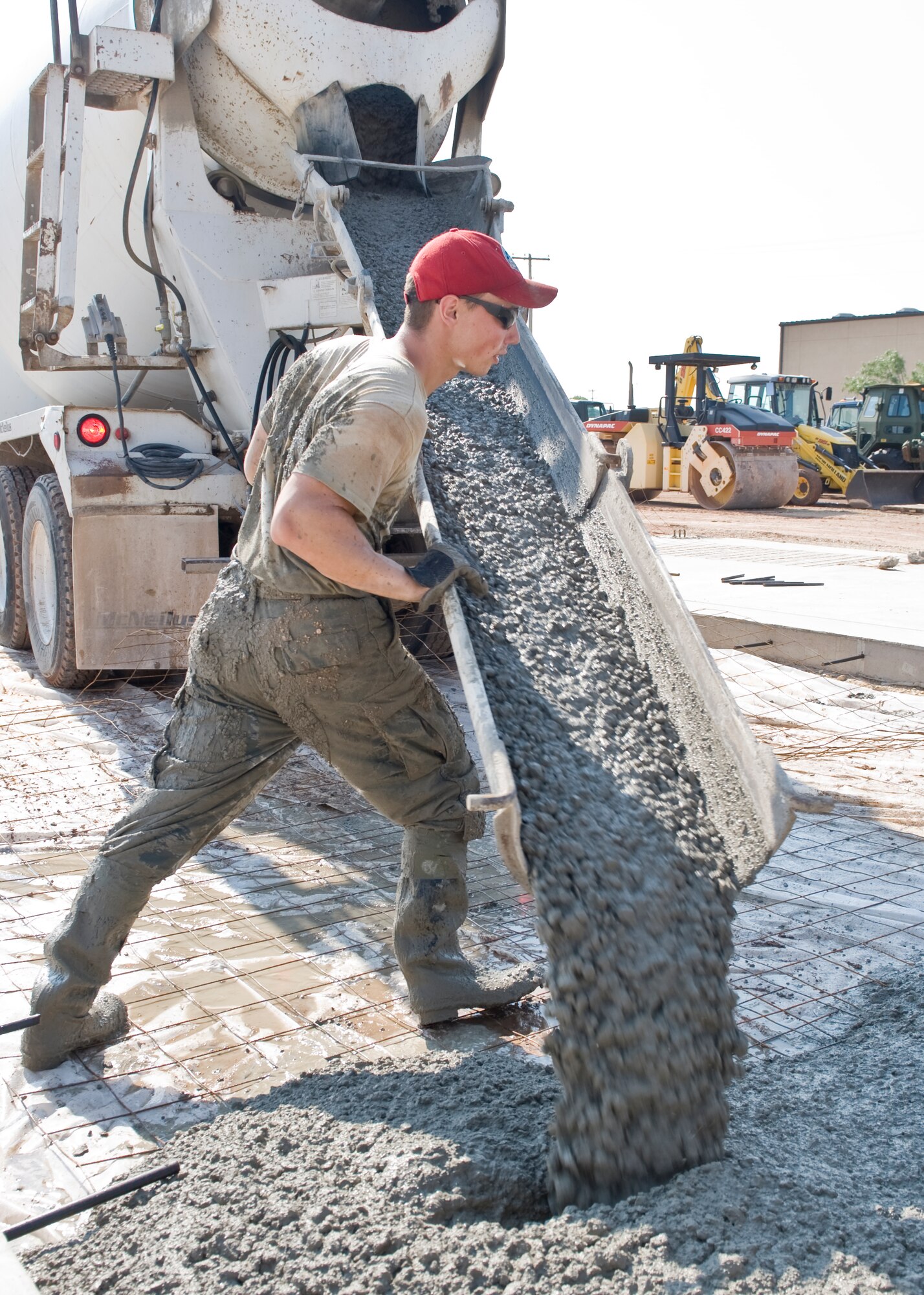 Airman 1st Class Derek Reimer, 819th Red Horse Squadron of Malmstrom AFB, Mont., pours concrete July 17, 2012, at Dyess Air Force Base, Texas. The poured concrete is for the foundation of an 8,500-square-foot facility that will provide the 7th CES a new logistics building, consolidating multiple facilities used by the squadron. (U.S. Air Force photo by Airman 1st Class Peter Thompson/ Released)