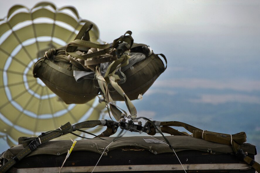 A fifteen-foot extraction parachute catches wind, pulling a heavy equipment platform out the rear of a 911th Airlift Wing C-130 Hercules during a training exercise above a designated drop zone in Cadiz, Ohio, July 14, 2012. Two G-12 Echo parachutes were used to safely land the 3,250 pound platform on its target, as 32nd Aerial Port Squadron members waited on the ground to recover the dropped cargo. (U.S. Air Force photo by Senior Airman Jonathan Hehnly/Released)