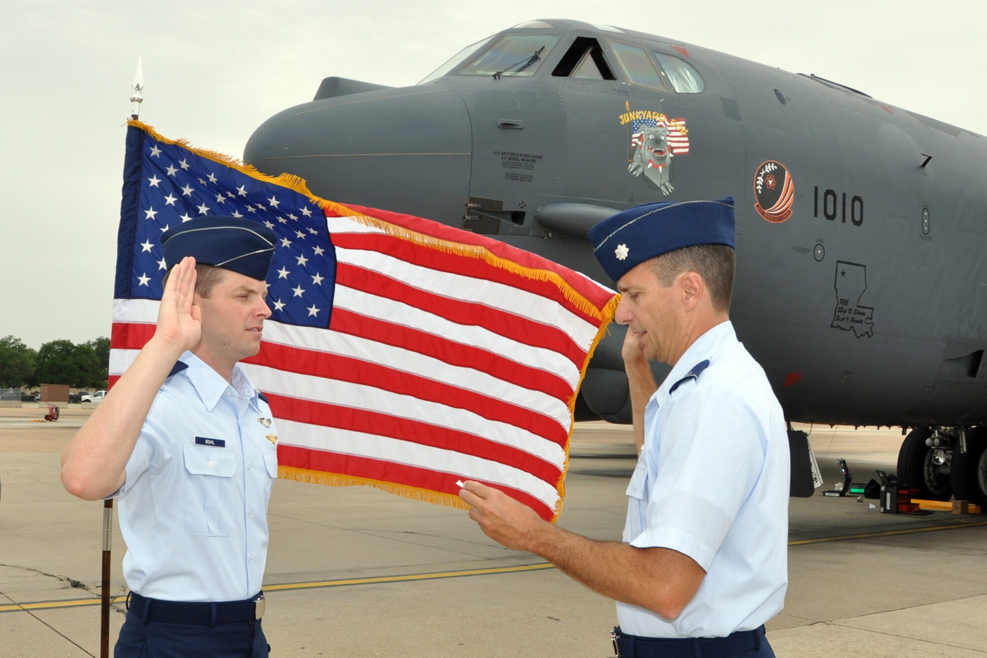 Capt. Aaron Bohl is administered the oath of office by Lt Col Denis Heinz, the commander of the 343rd Bomb Squadron,  on the ramp at Barksdale Air Force Base, La., on July 2. Bohl spent a little over eight years on active duty in the U.S. Marine Corps. During his time as a Marine officer he flew the AH-1W Super Cobra at Camp Pendleton, Calif., and Marine Corps Air Station Miramar, Calif. He came to the Air Force Reserve to fly the B-52 Startofortress. (U.S. Air Force photo by Master Sgt. Jeff Walston) 