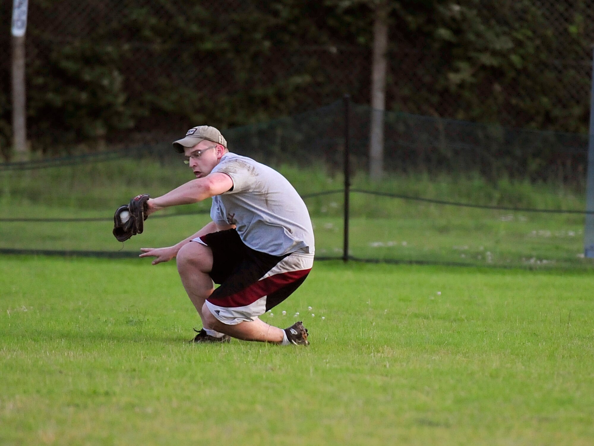 RAF MILDENHALL, England – Christopher Klare, 488th Intelligence Squadron, makes a catch during an intramural softball game July 11, 2012, at RAF Mildenhall. The 488th IS lost 13-6 to the 100th Logistics Readiness Squadron. (U.S. Air Force photo/Senior Airman Ethan Morgan)