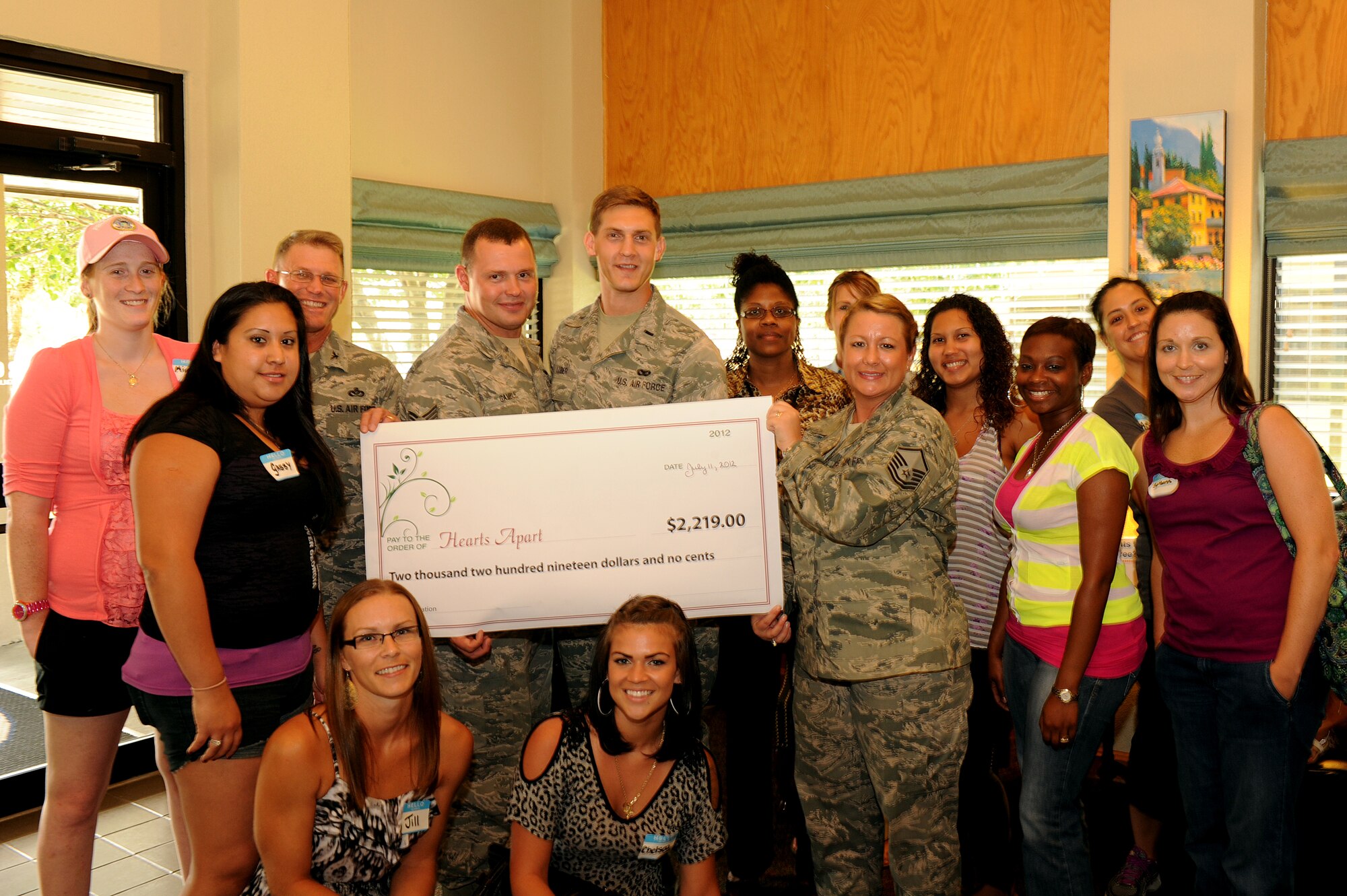 Col. Curt Van de Walle, commander of 1st Special Operations Mission Support Group, presents Master Sgt. Natalie Sockman, NCO In-Charge of personnel and family readiness at the Airman & Family Readiness Center, with a check for $2,219 at the A&FRC July 11, 2012. The funds were raised during a golf tournament for the Hurlburt Field Hearts Apart program. (U.S. Air Force photo/Senior Airman Eboni Reams) 