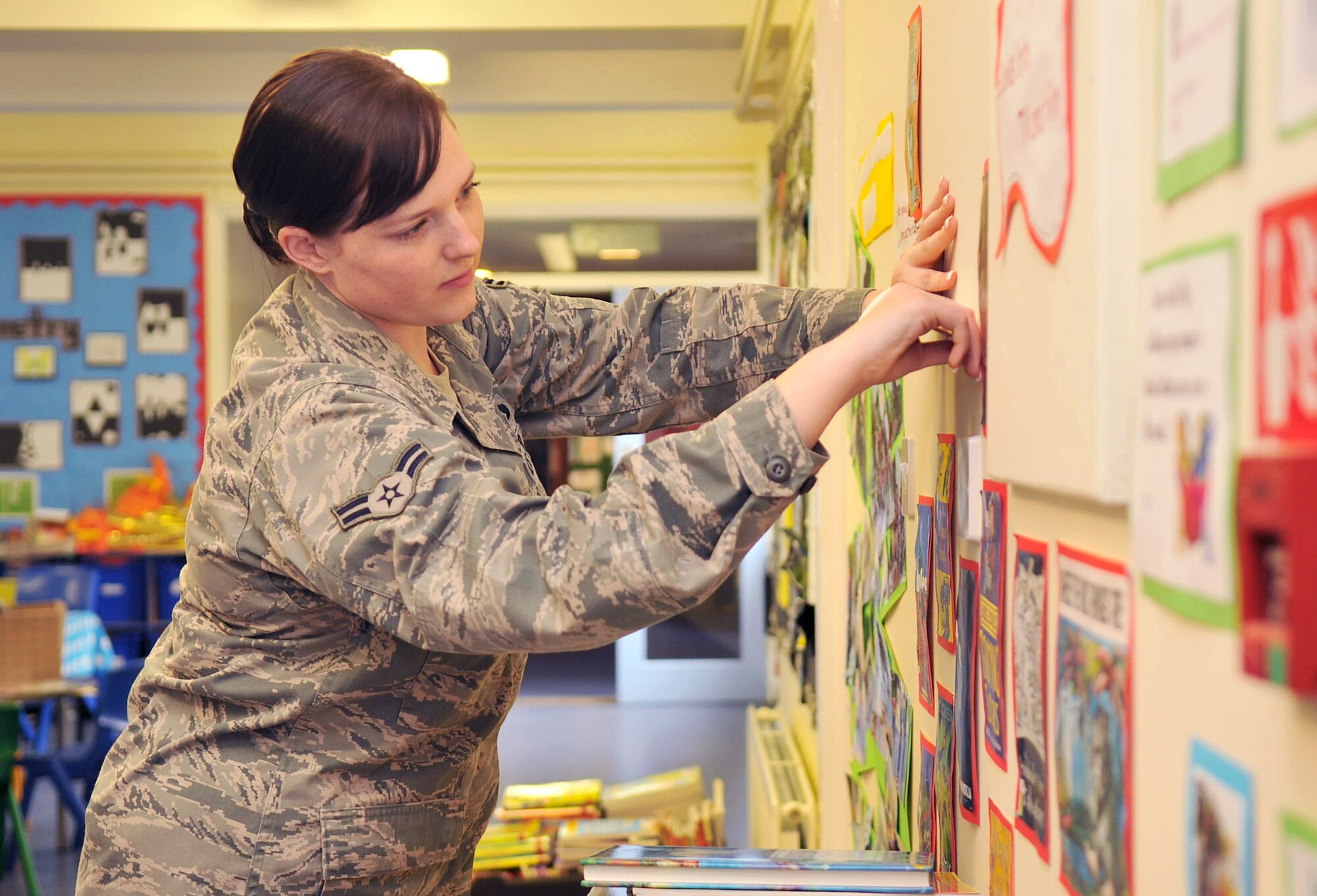 BECK ROW, England - Airman 1st Class Jessica Keeler, 100th Air Refueling Wing, removes art displays from a wall at the Beck Row Primary School July 16, 2012. Keeler, and several other Airmen from RAF Mildenhall, assisted the school in setting up a new library room. (U.S. Air Force photo/Senior Airman Jerilyn Quintanilla) 