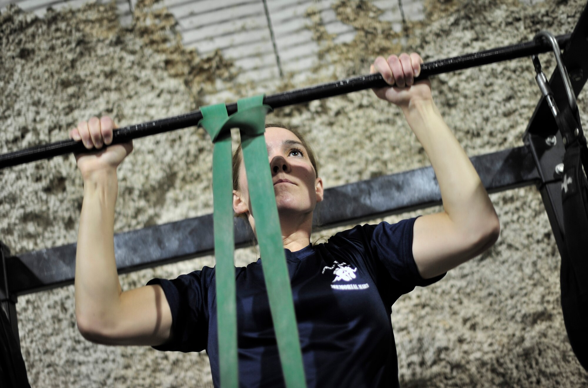 U.S. Air Force 2nd LT Noel Carroll, Flight Nurse, 455th Expeditionary Aeromedical Sq., works out at a fitness center named after her brother, USAF SSgt Timothy Davis, Bagram Airfield, Afghanistan, May 31, 2012. The fitness center, called "The Rock", displays a memorial for her brother, who in 2009 was killed in action after an improvised explosive device (IED) struck his convoy. Davis was a Combat Controller.  

(U.S. Air Force photo/Staff Sgt. Clay Lancaster/Not Released)