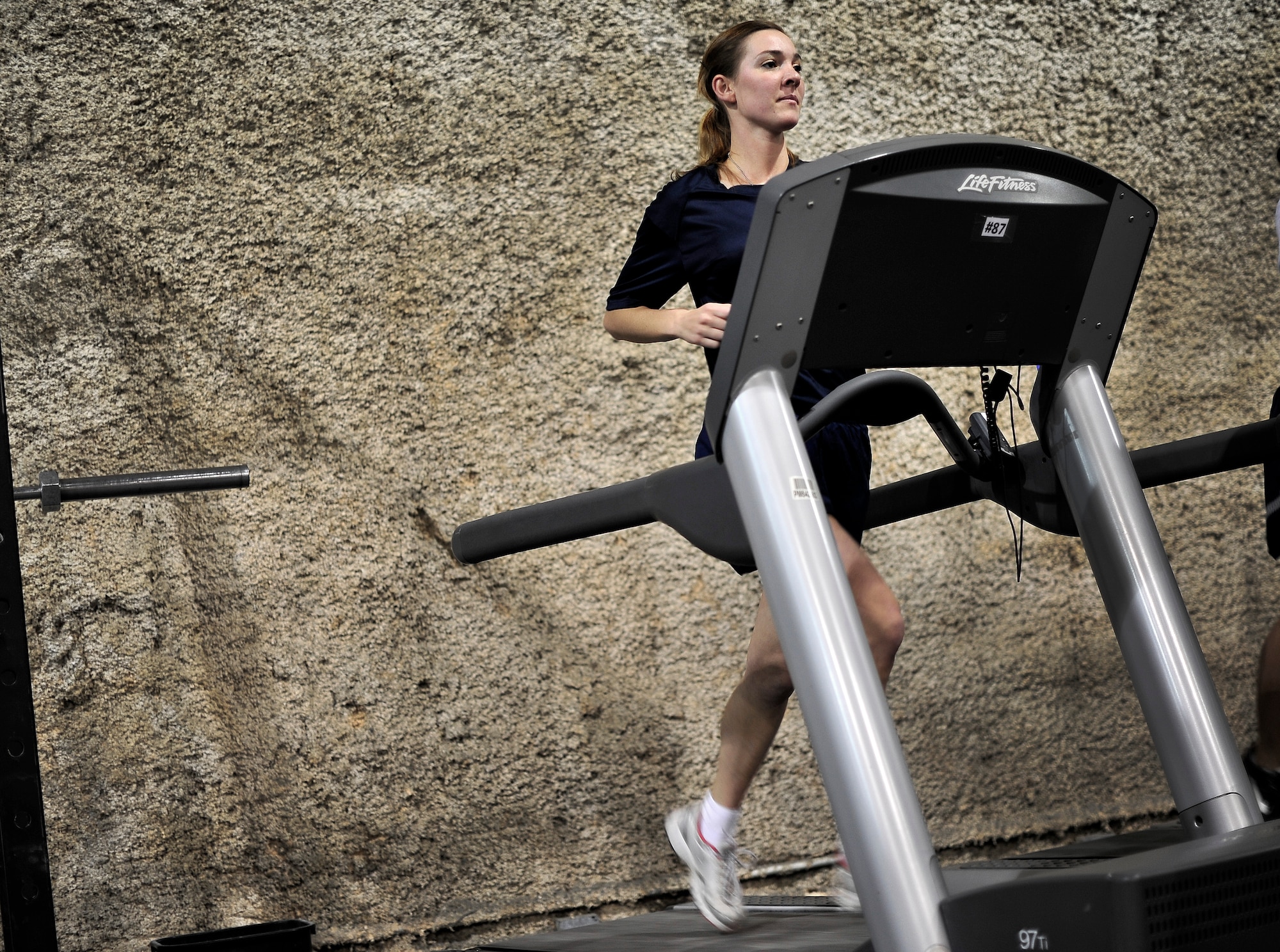 U.S. Air Force 2nd LT Noel Carroll, Flight Nurse, 455th Expeditionary Aeromedical Sq., works out at a fitness center named after her brother, USAF SSgt Timothy Davis, Bagram Airfield, Afghanistan, May 31, 2012. The fitness center, called "The Rock", displays a memorial for her brother, who in 2009 was killed in action after an improvised explosive device (IED) struck his convoy. Davis was a Combat Controller.  

(U.S. Air Force photo/Staff Sgt. Clay Lancaster/Not Released)