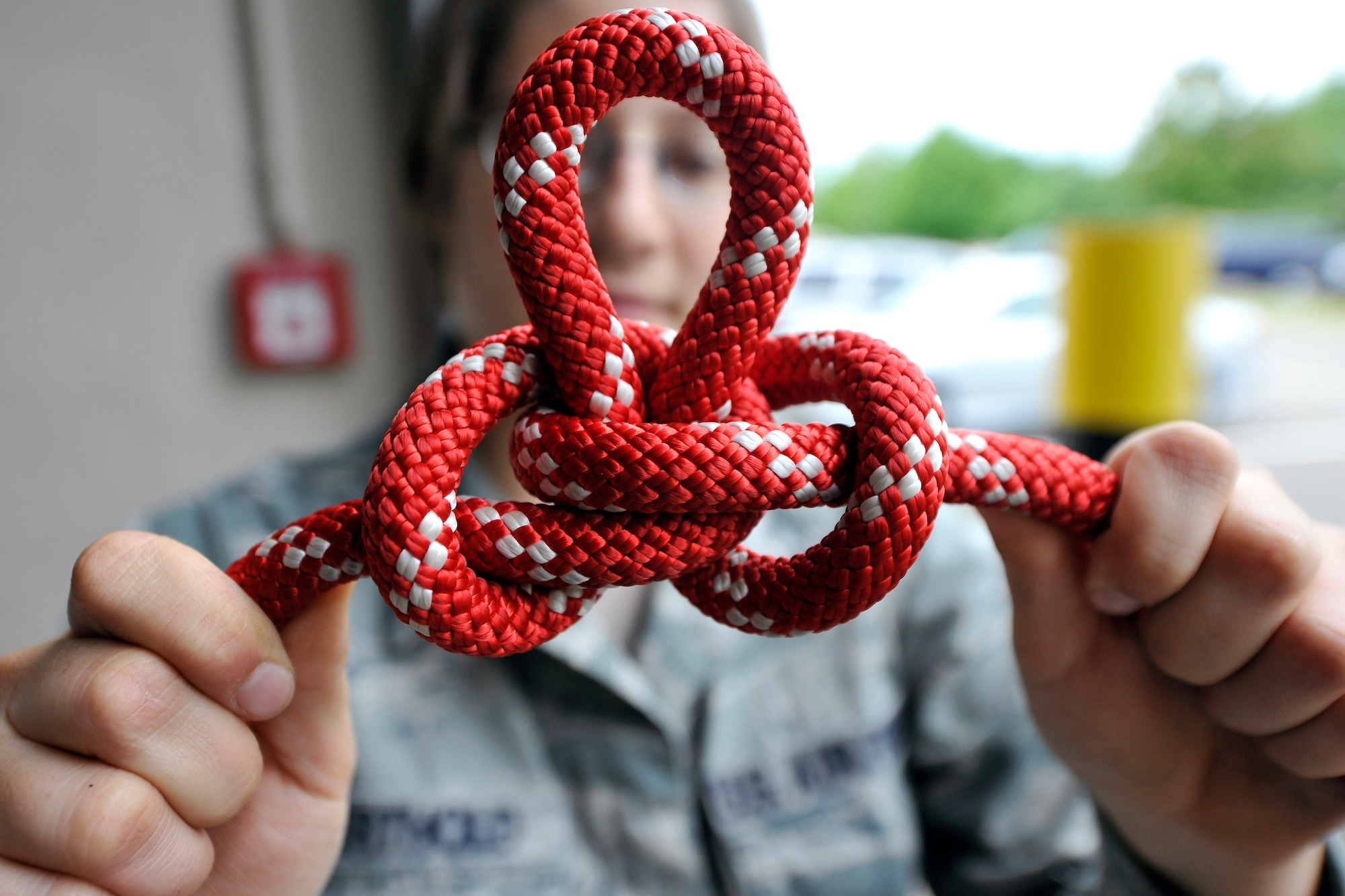 Senior Airman Sidney Berthold, 1st Communication Maintenance Squadron cable and antenna team, displays a butterfly knot on Kapuan Air Station, Germany July 11, 2012. The 1st CMXS provides climb and rescue certifiers for all personnel in the U.S. Air Forces in Europe Theater, training more than 70 technicians annually saving the Air Force $384 thousand in contractor fees.  (U.S. Air Force photo/Senior Airman Chris Willis)