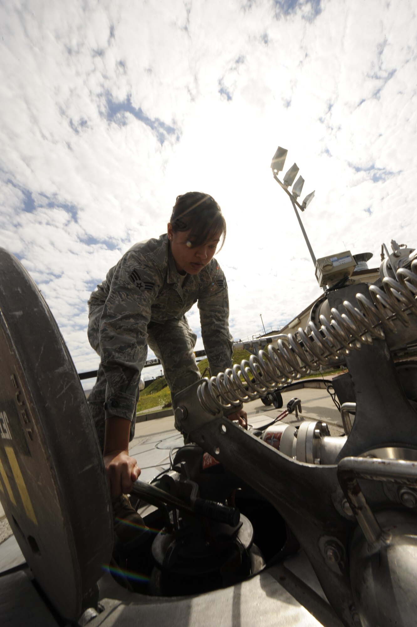Senior Airman Janine Trammel, 86th Logistics Readiness Squadron fuels technician, hooks up a moose head to a fuels pit to prepare for a refuel on Ramstein Air Base, Germany, July 10, 2012. Fuels help support the mission by continuously providing quality grade jet fuel. (U.S. Air Force photo/ Senior Airman Aaron-Forrest Wainwright)