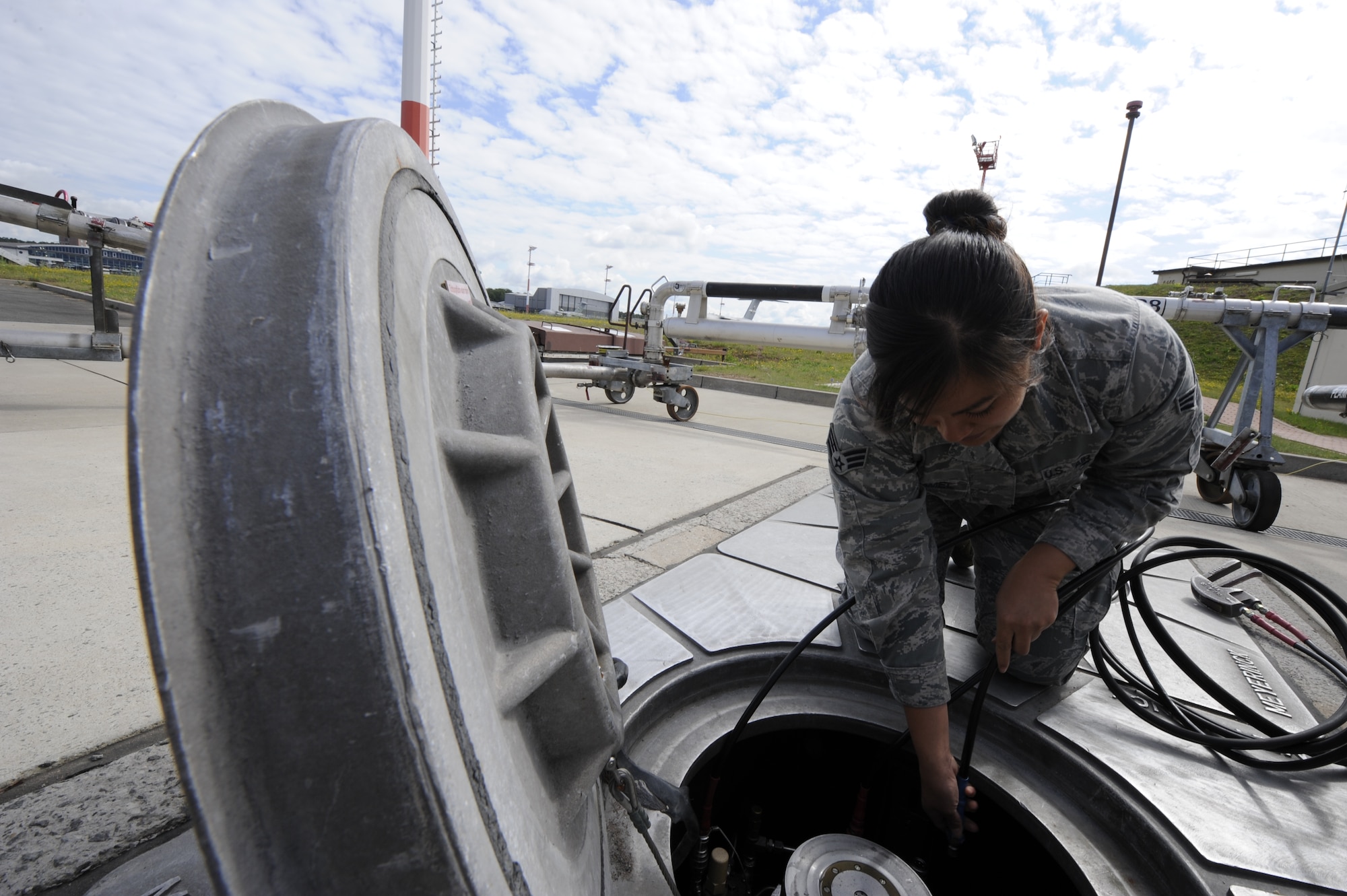 Senior Airman Janine Trammel, 86th Logistics Readiness Squadron fuels technician, opens a fuels pit to prepare for a refuel on Ramstein Air Base, Germany, July 10, 2012. Fuels help support the mission by continuously providing quality grade jet fuel. (U.S. Air Force photo/ Senior Airman Aaron-Forrest Wainwright)