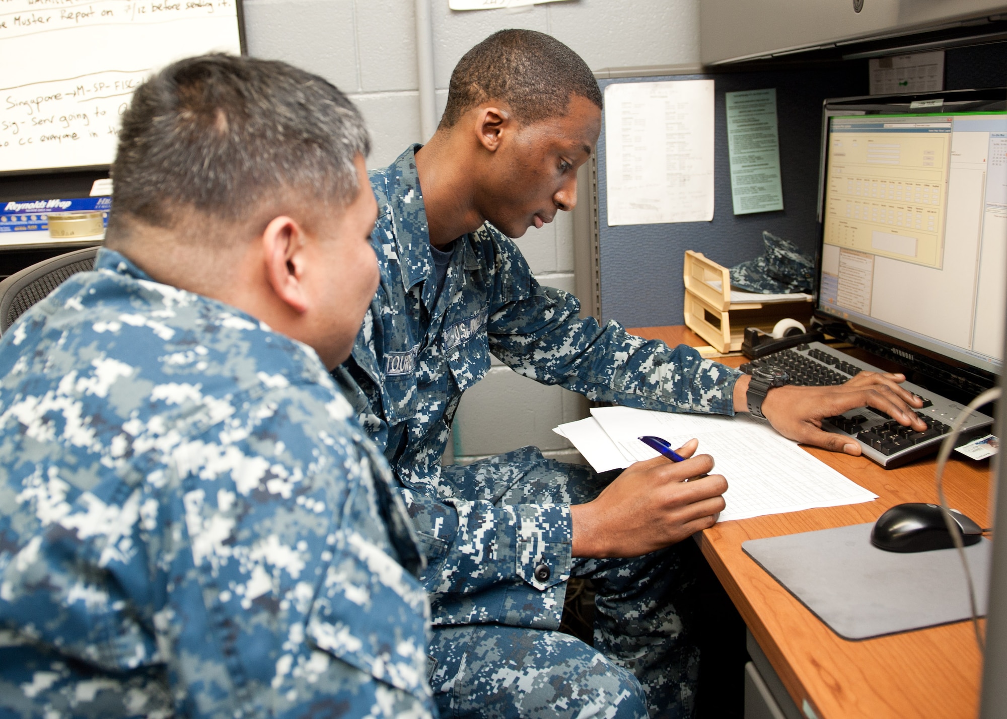 YOKOTA AIR BASE, Japan -- Seaman Naby Toure, right, and Petty Officer 2nd Class Allen Glenn, left, Navy Overseas Air Cargo Terminal logistics specialists, look over paperwork to ensure an inbound truck of supplies from Naval Fleet Activities Yokosuka, Japan, contains all the materials needed for mission requirements at Yokota Air Base, Japan, July 12, 2012.  NOACT Yokota is the U.S. Navy’s main logistics pipeline and largest air cargo terminal in the Pacific. (U.S. Air Force photo by Senior Airman Andrea Salazar)