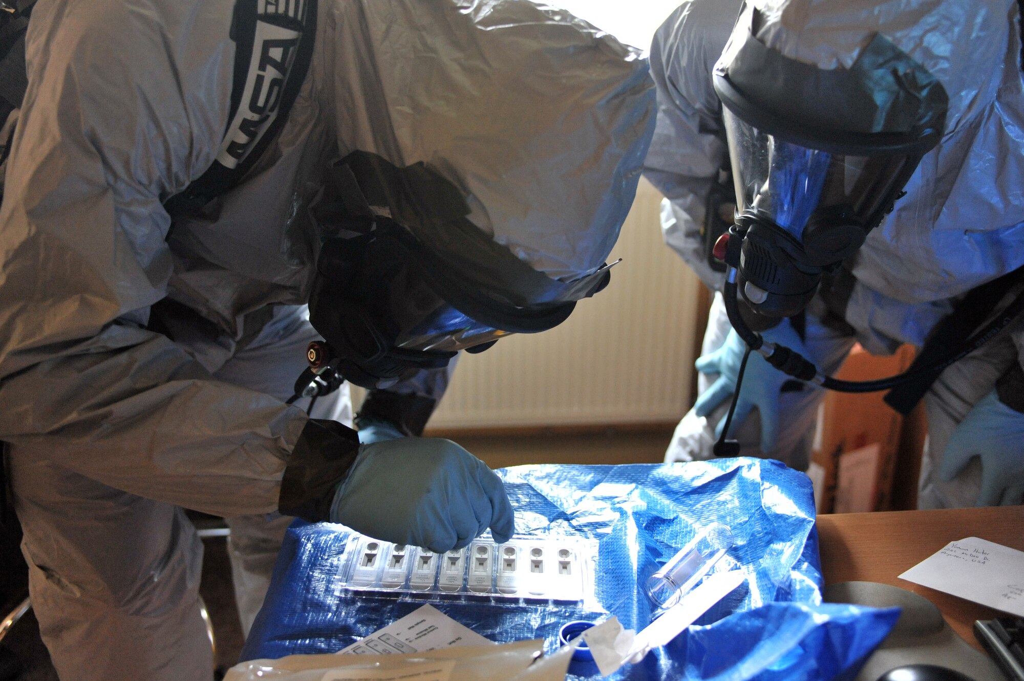 Members of the 886th Civil Engineer Squadron emergency management, perform samplings for an exercise during the monthly Prime Base Engineer Emergency Force training day, Ramstein Air Base, Germany, July 12, 2012.  The 86th CEG provide, maintain and protect real property assigned to the 86th Airlift Wing, the Kaiserslautern Military Community and associated units while supporting worldwide contingencies with trained combat engineers and equipment. (U.S. Air Force photo/Senior Airman Caitlin O'Neil-McKeown)